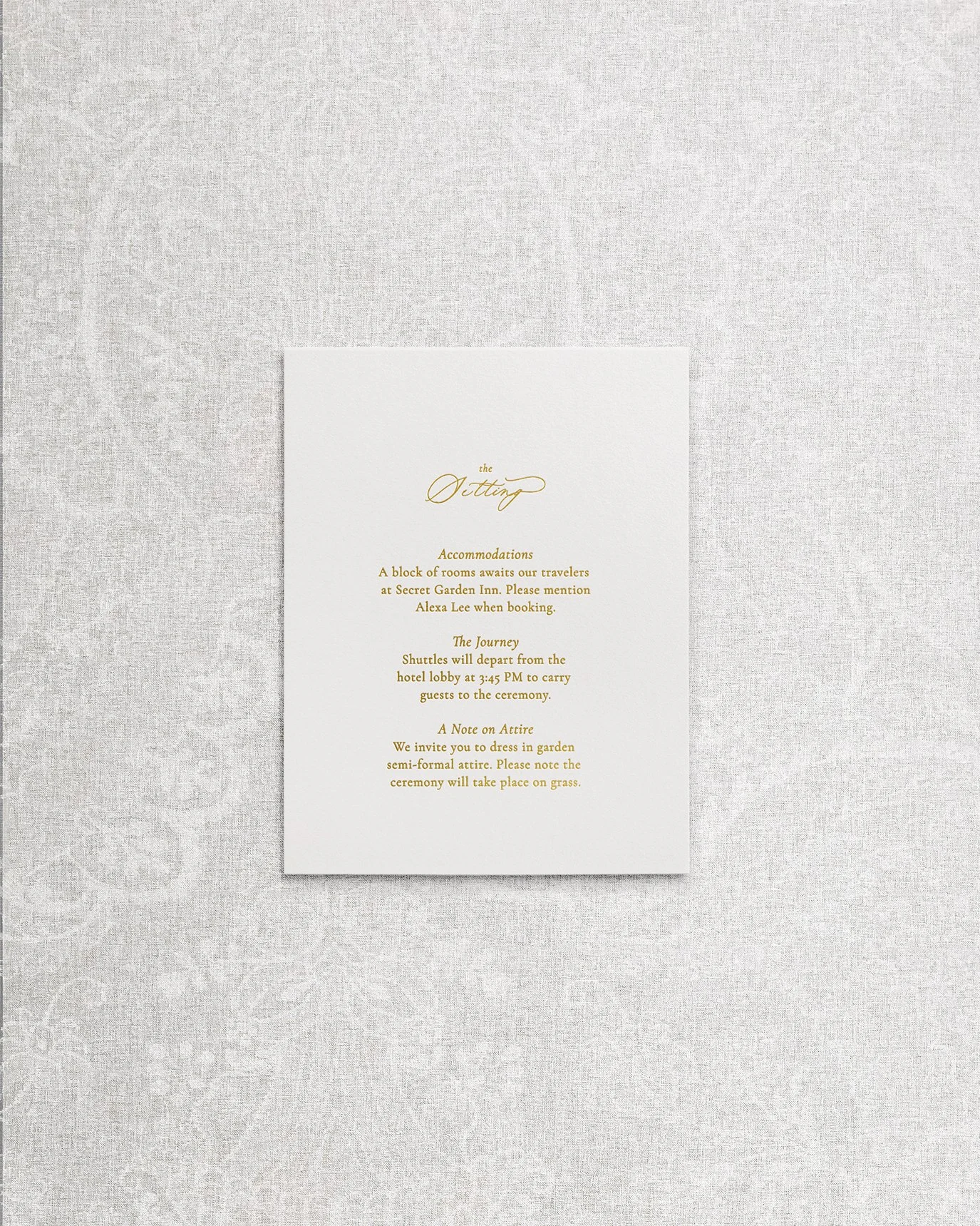 An elegant and simple wedding invitation details card featuring gold foil calligraphy on white cardstock.