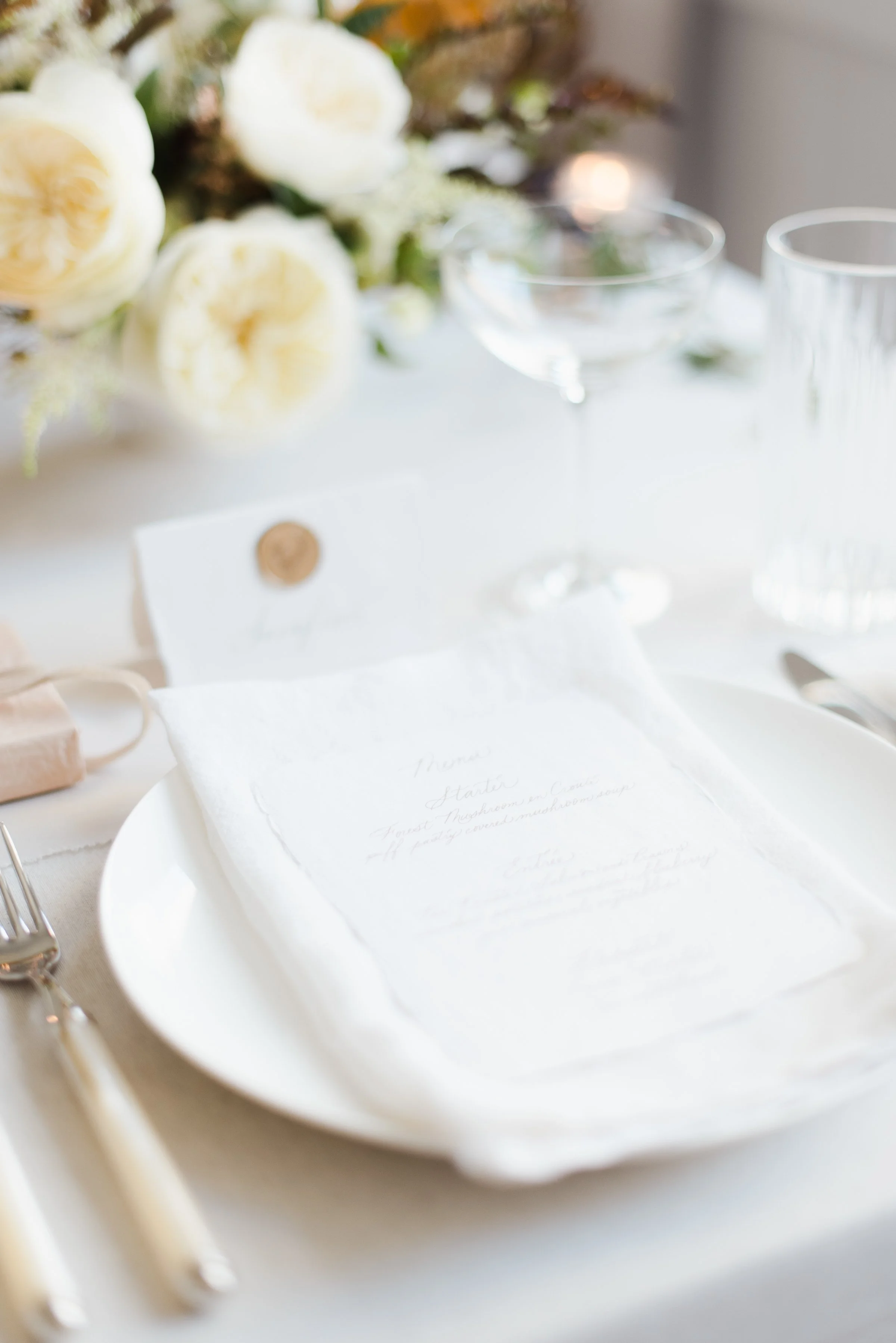 Wedding invitation menu on table setting.