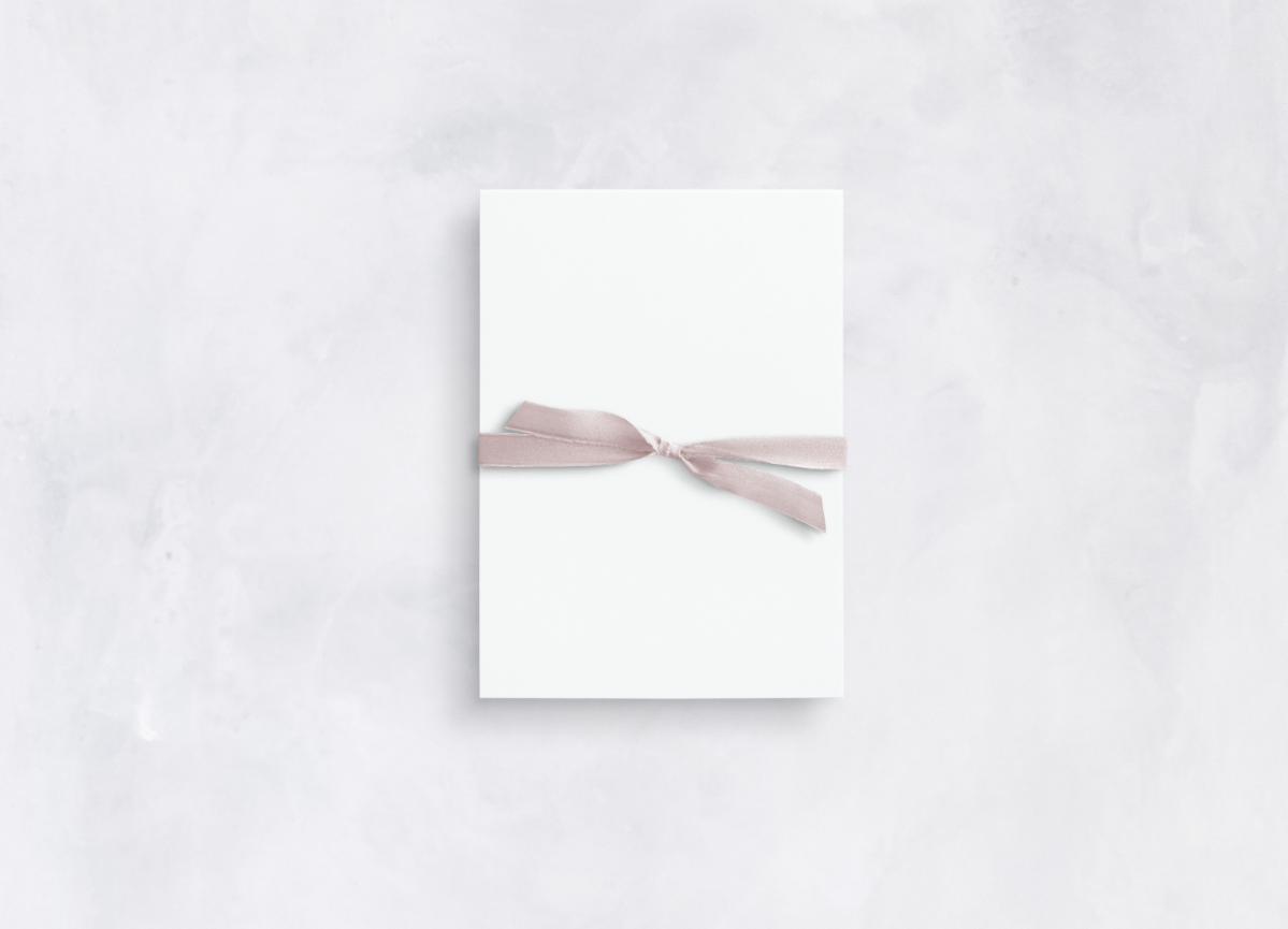 Blush pink silk ribbon tied in decorative knot
