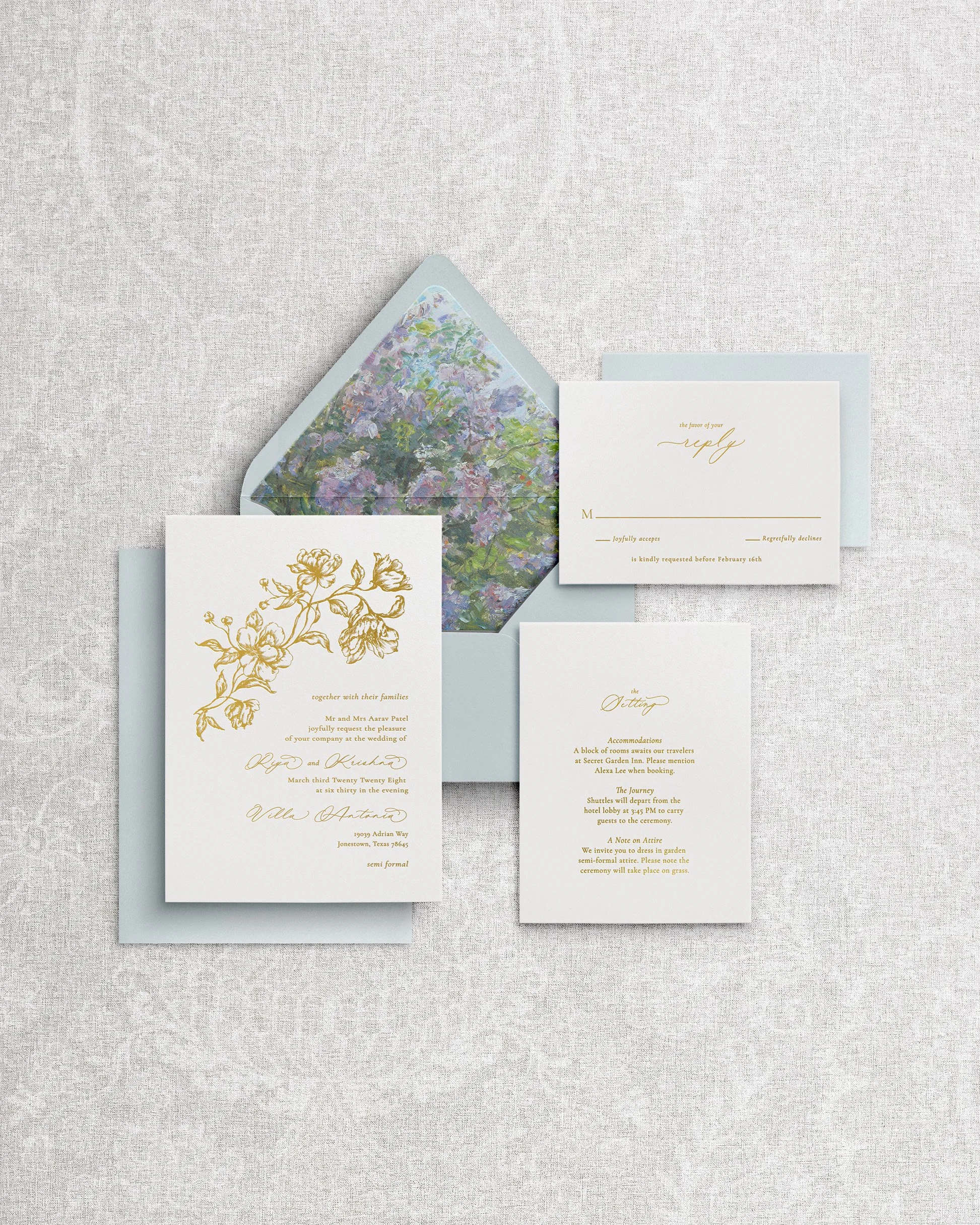 Signature wedding invitation: white cotton cardstock with floral debossing and gold foil letterpress calligraphy.
