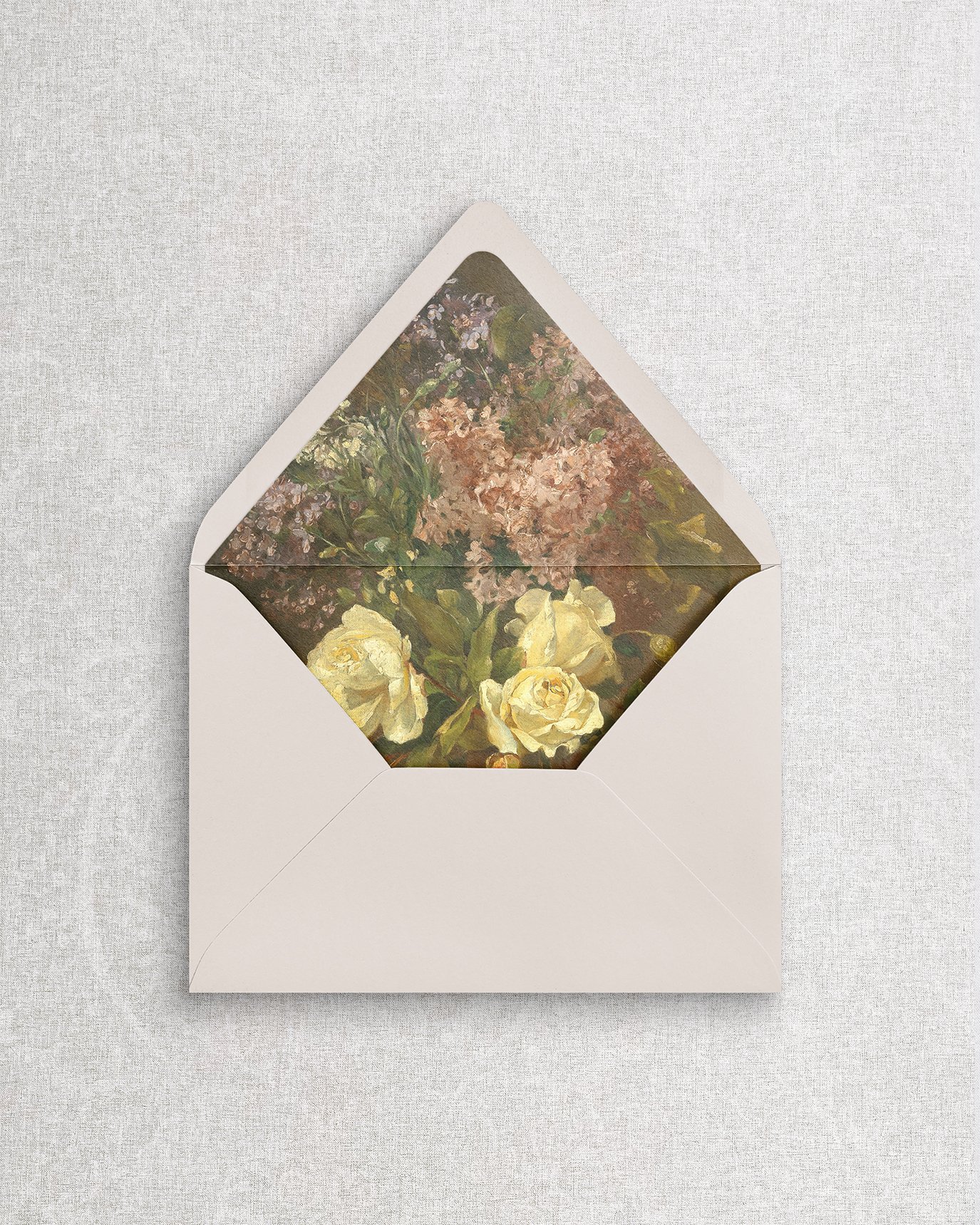 An elegant, simple wedding invitation envelope featuring a romantic floral liner, perfect for luxury stationery suites.