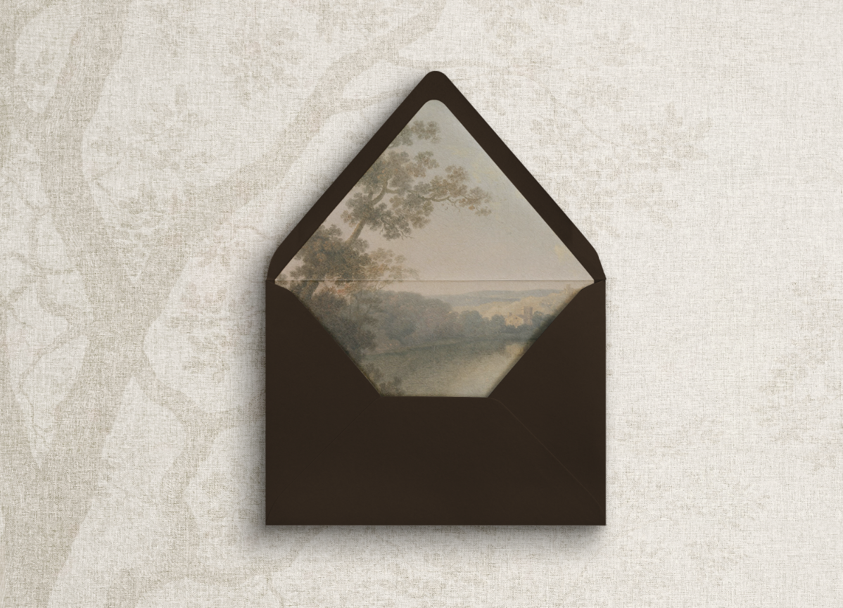 Elegant wedding invitation envelope with a moody landscape liner.