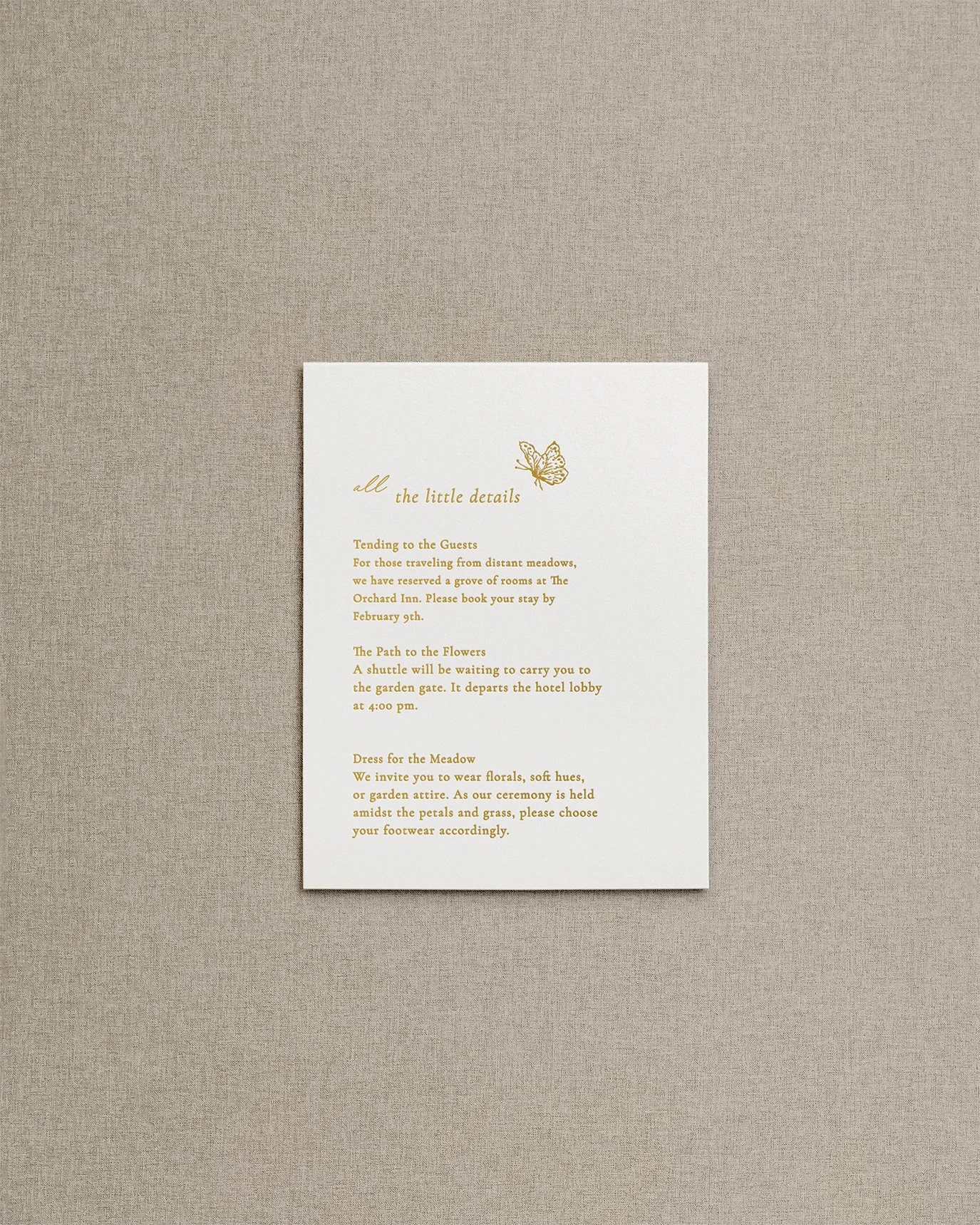 Elegant, simple wedding invitation details card with gold foil calligraphy and a delicate butterfly illustration.