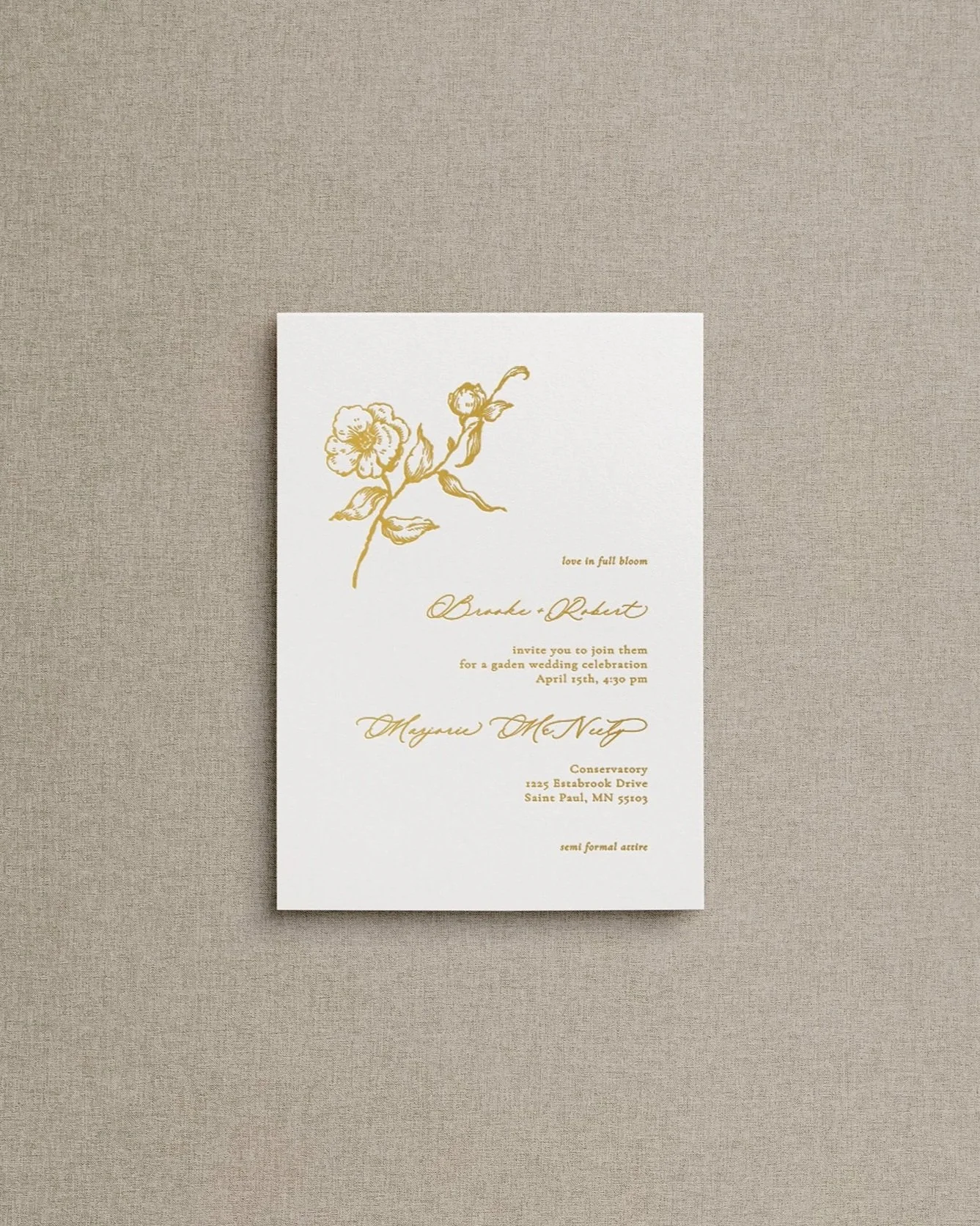Main invitation on white cardstock with gold letterpress mixed calligraphy text and fine art rose in upper left corner.