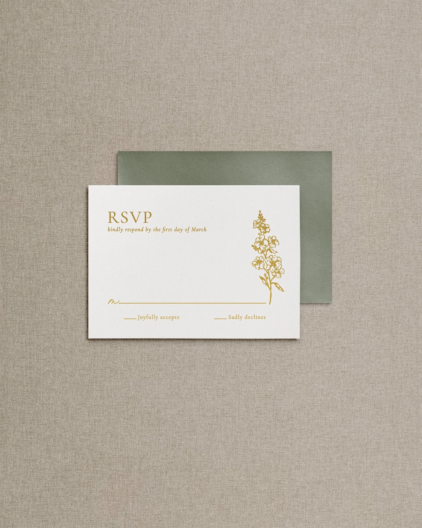 Elegant, simple wedding invitation RSVP card with gold foil calligraphy and a delicate floral illustration.