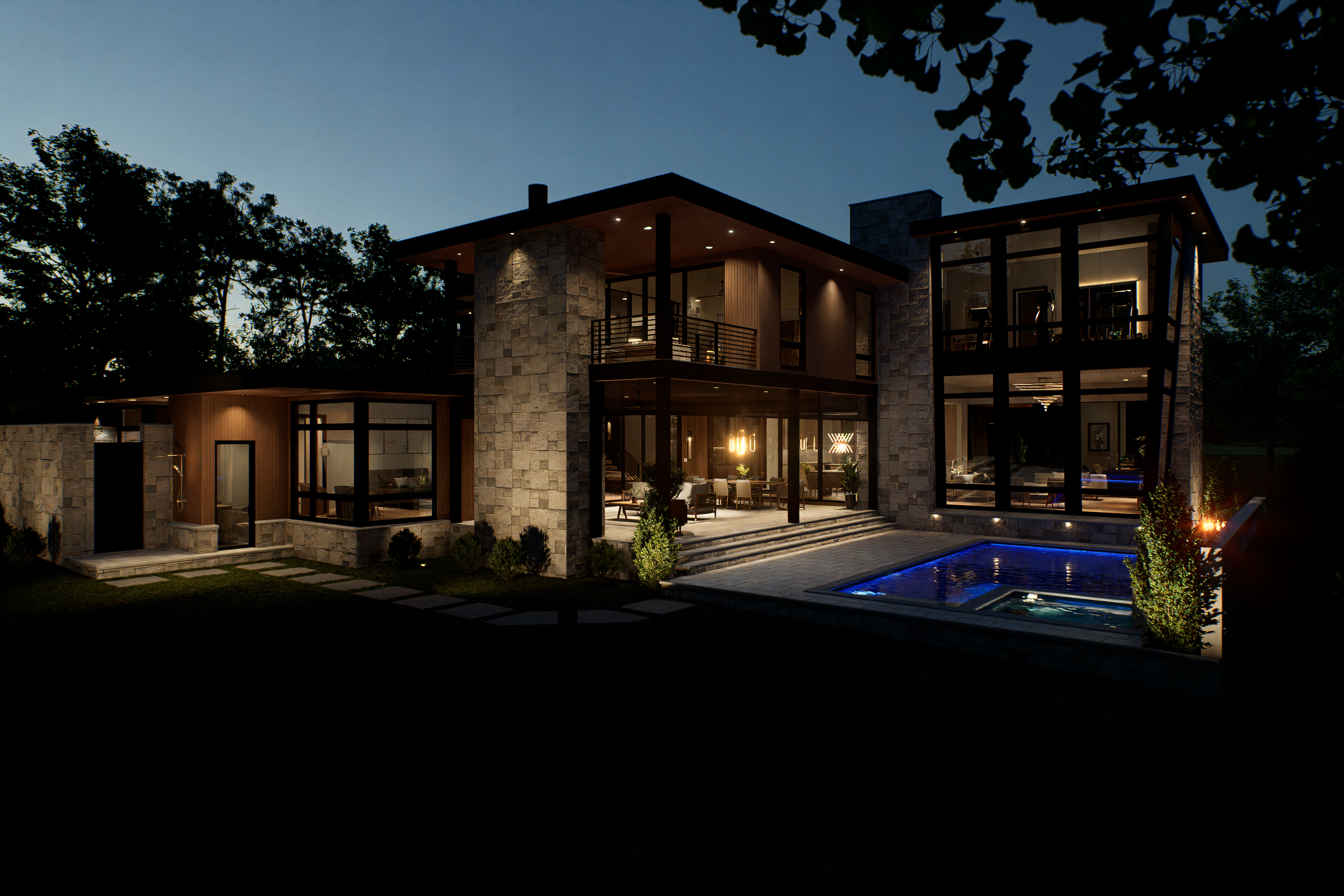 Modern two-story house at night with illuminated interior, large glass windows, stone and wood exterior, outdoor patio, swimming pool with blue lighting, and landscaped yard.