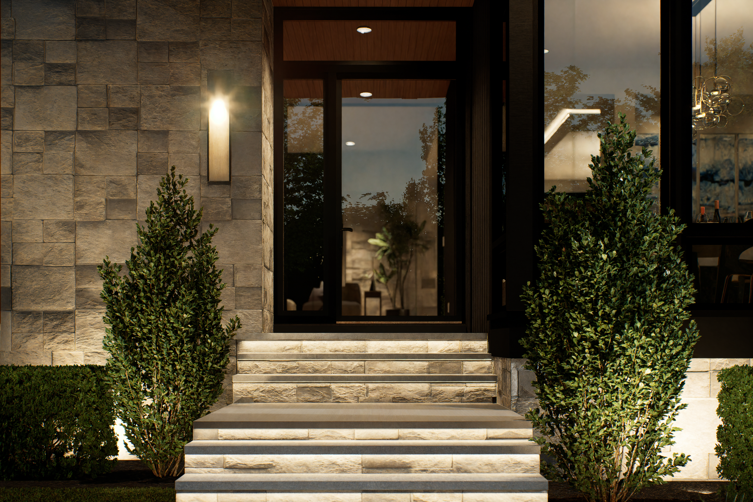 Exterior view of a modern house entrance with stone steps, two trimmed bushes, a wall-mounted light, and glass doors, illuminated at dusk.