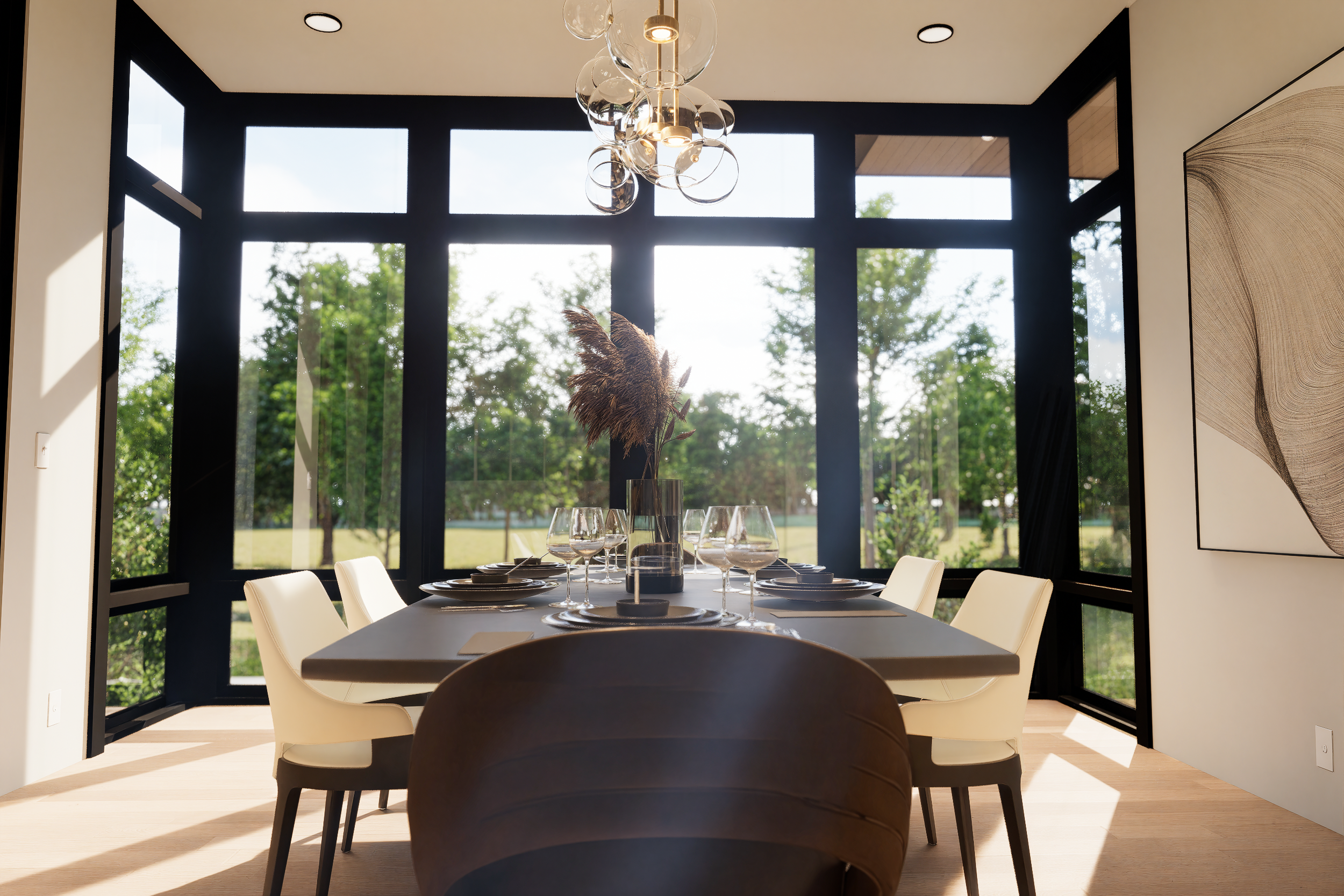 Modern dining room with large windows, a black table set with wine glasses and a centerpiece, and white chairs around the table.
