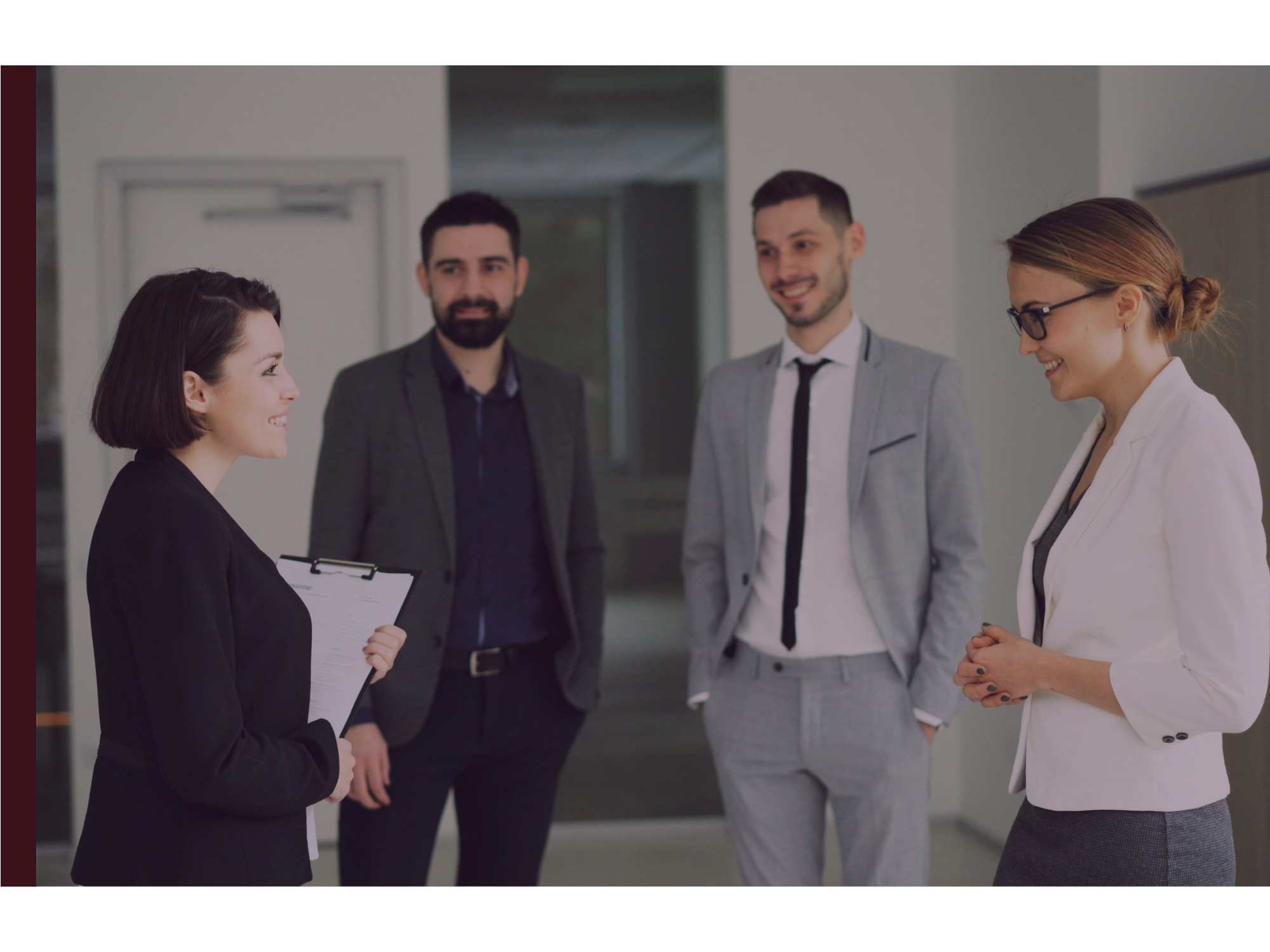 Four colleagues stand together chatting