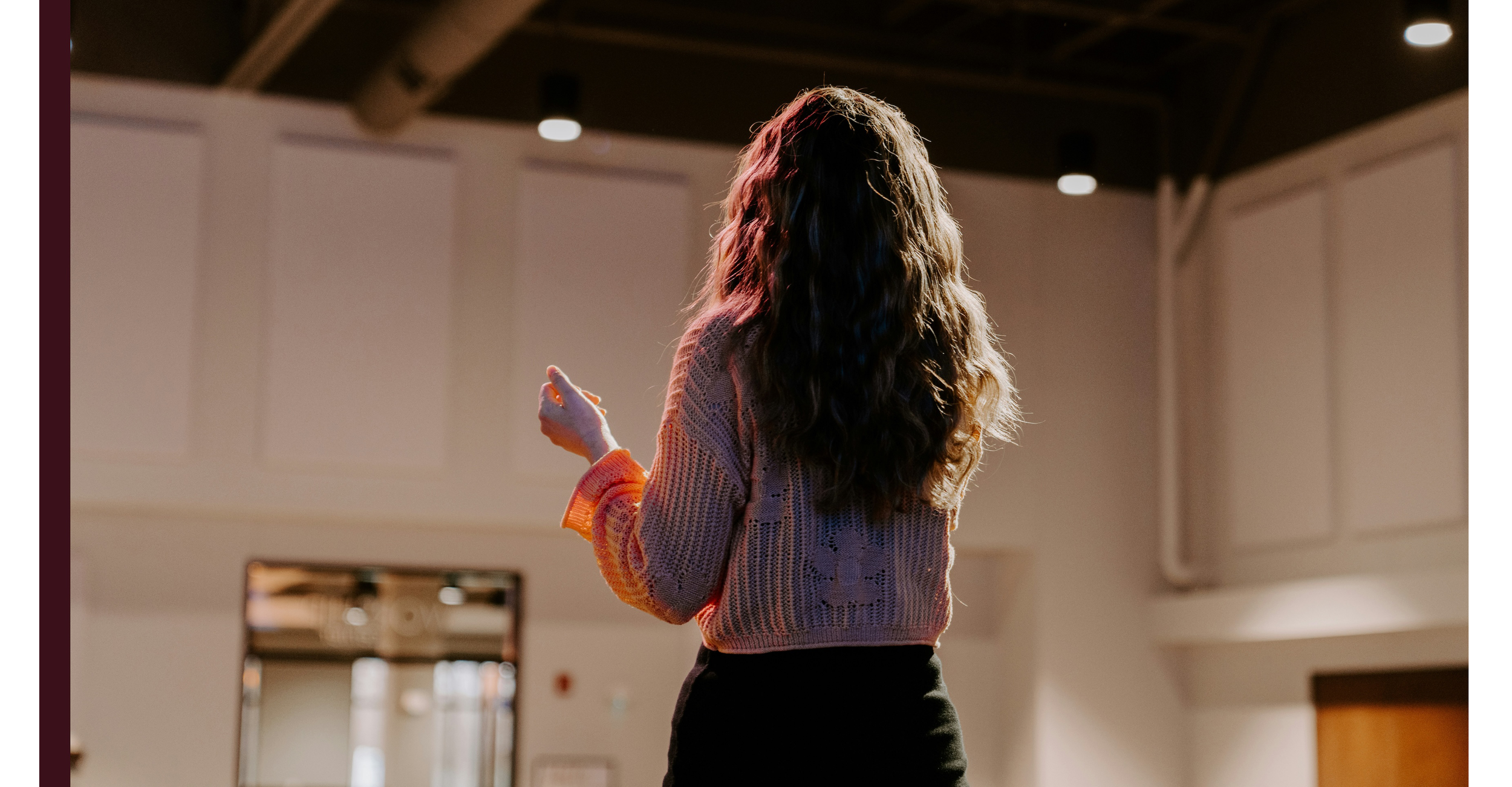 An individual gives a speech in the spotlight