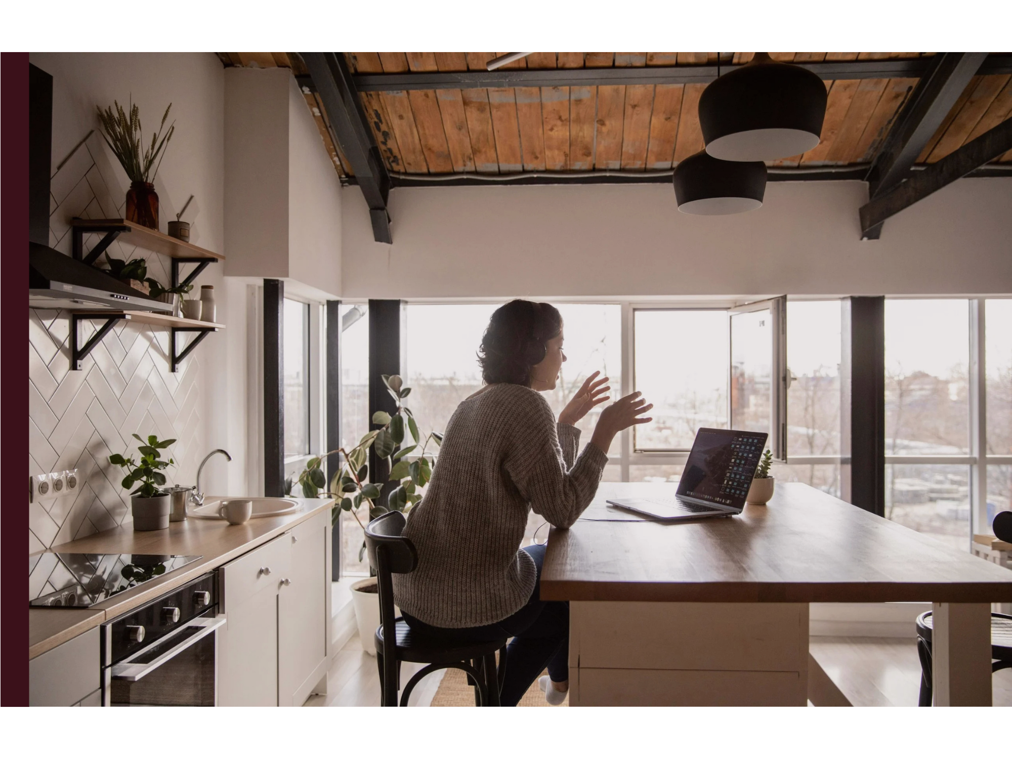 A woman sits and speaks in a video call in her home