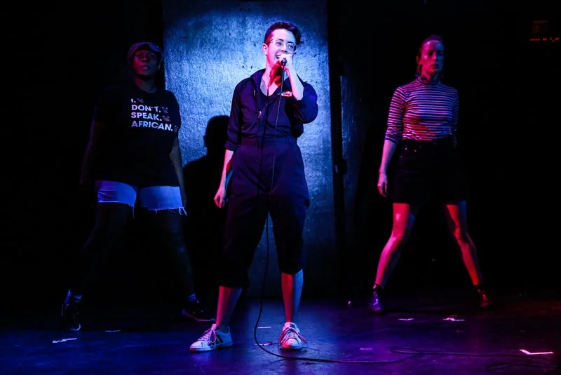 neo-futurists-lee-singing-with-dancers.jpeg
