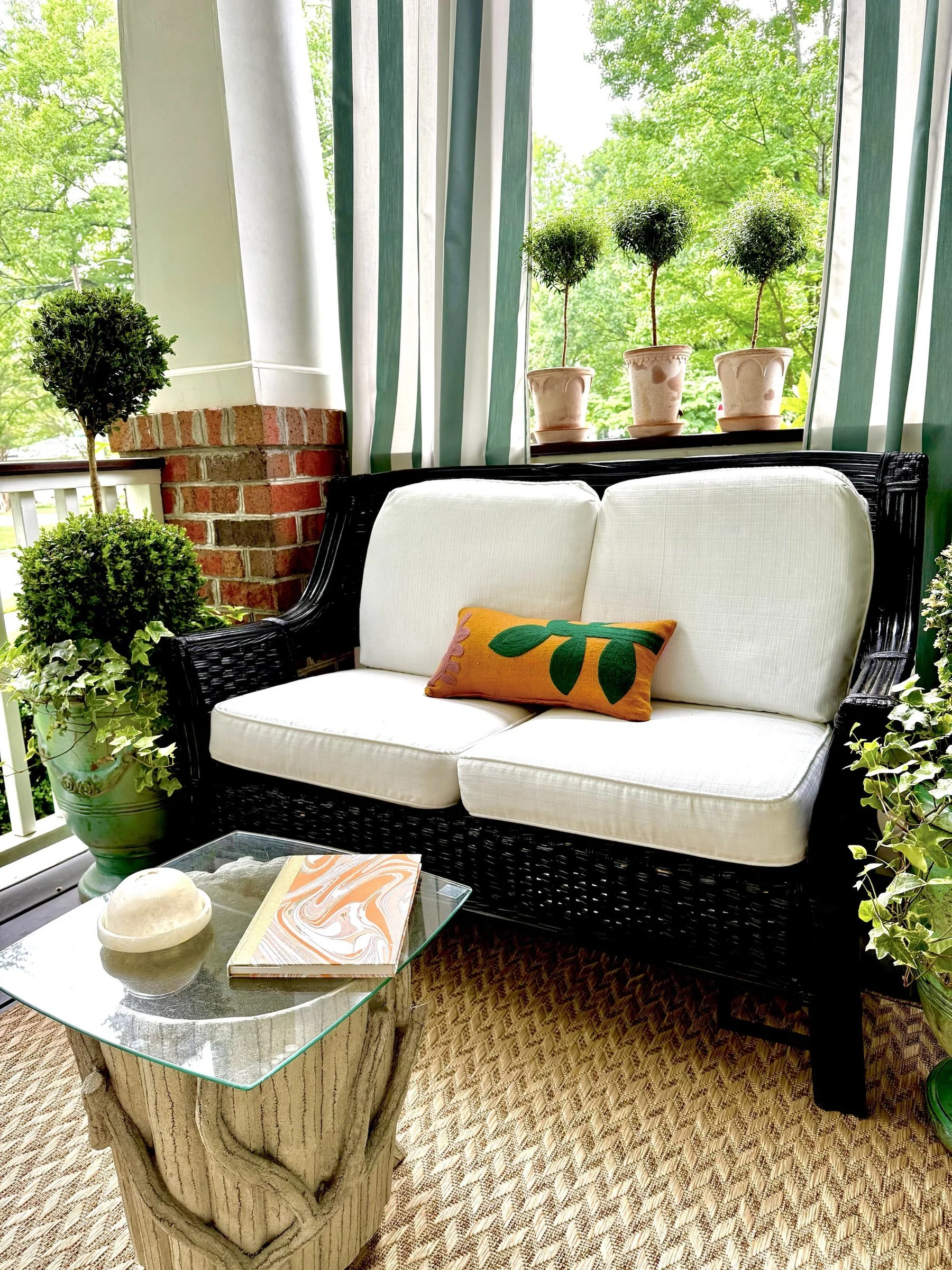 04-porch-rattan-loveseat-topiaries.jpg
