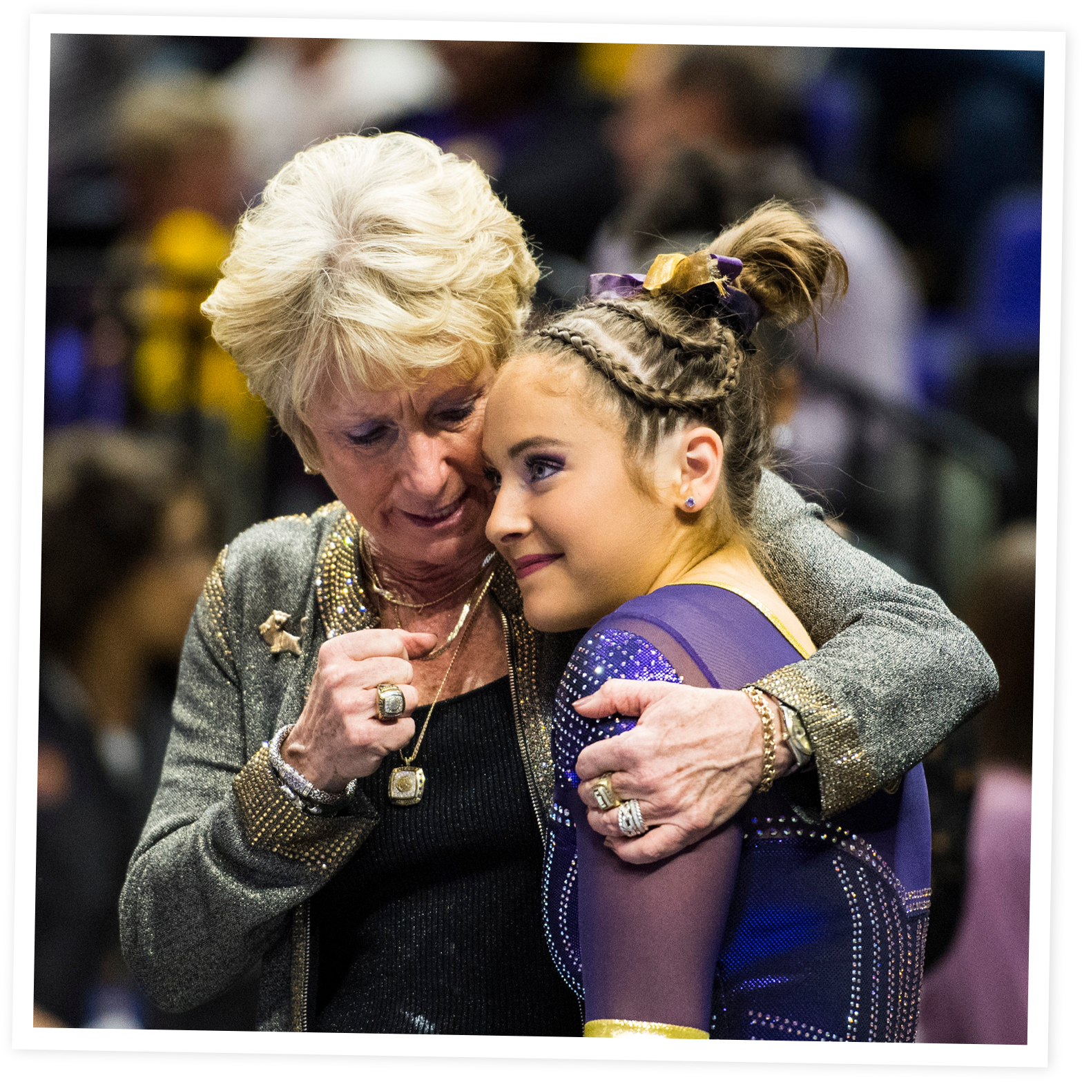 D-D and a young girl are sharing an emotional hug at an event.