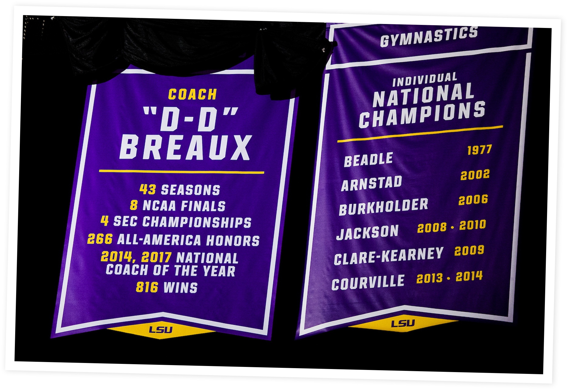 Two LSU banners on a black background, one highlighting Coach D-D Breaux's achievements with 43 seasons, 8 NCAA Finals, 4 SEC Championships, 266 All-America Honors, national Coach of the Year in 2014 and 2017, and 816 wins; the other listing LSU women's gymnastics individual national champions with names and years, including Beadle (1977), Arnstad (2002), Burkholder (2006), Jackson (2008-2010), Clare-Kearney (2009), and Courville (2013-2014).