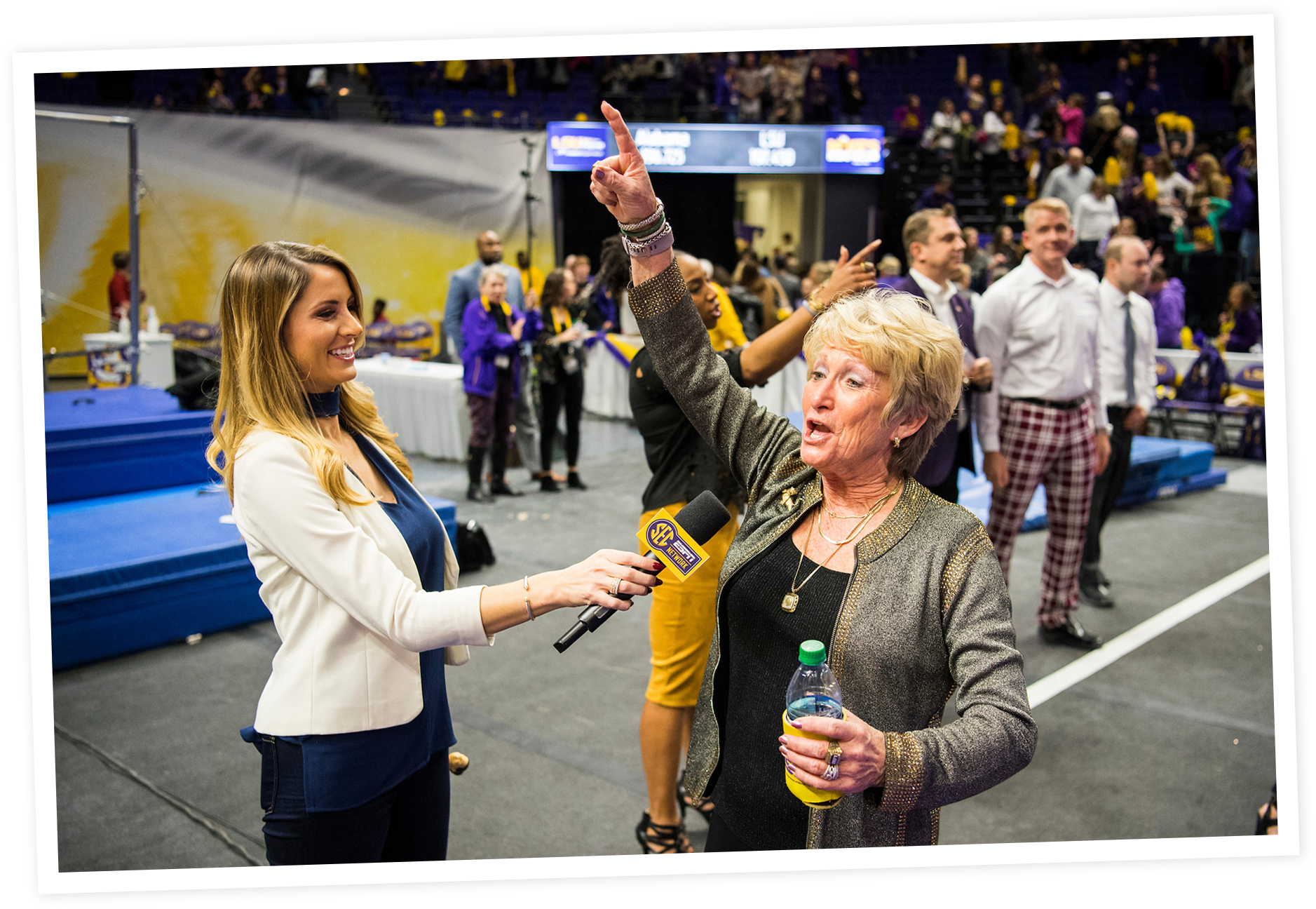 A woman holding a microphone with SEC network logo interviews