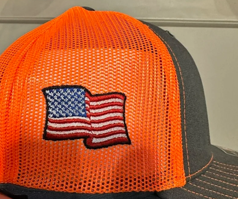 Orange mesh baseball cap with an embroidered American flag patch on the front.