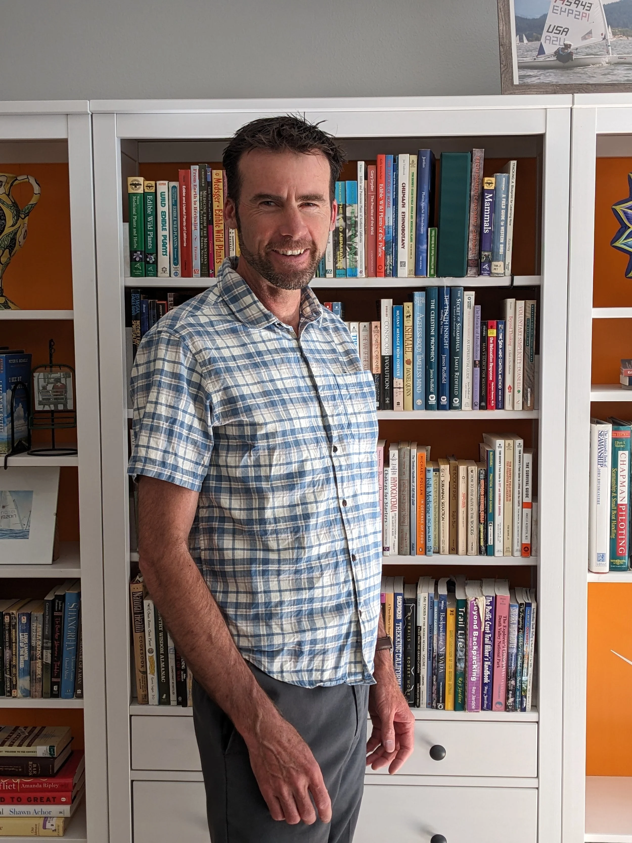 David Anthes in front of a bookshelf