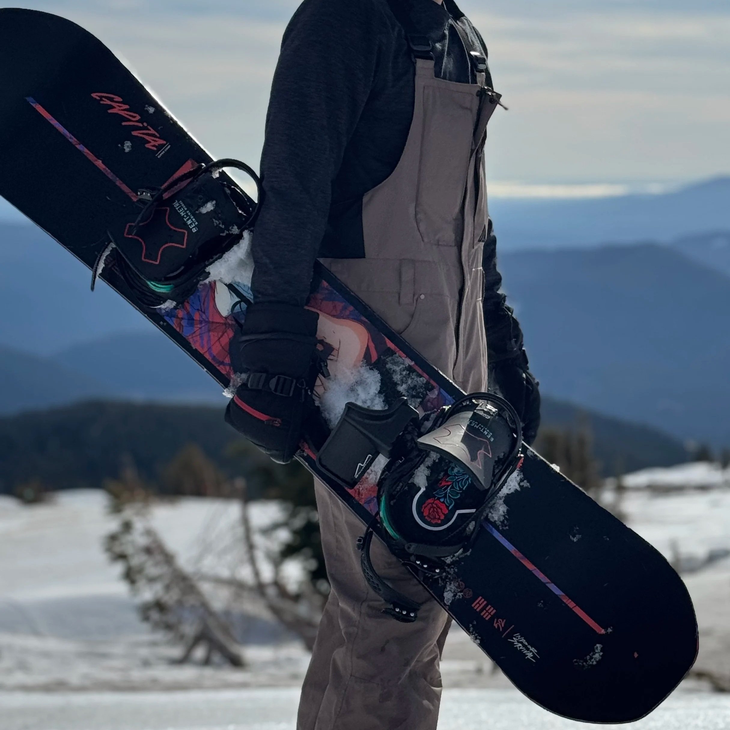 Snowboarder Holding Snowboard with BootDock on Mountain