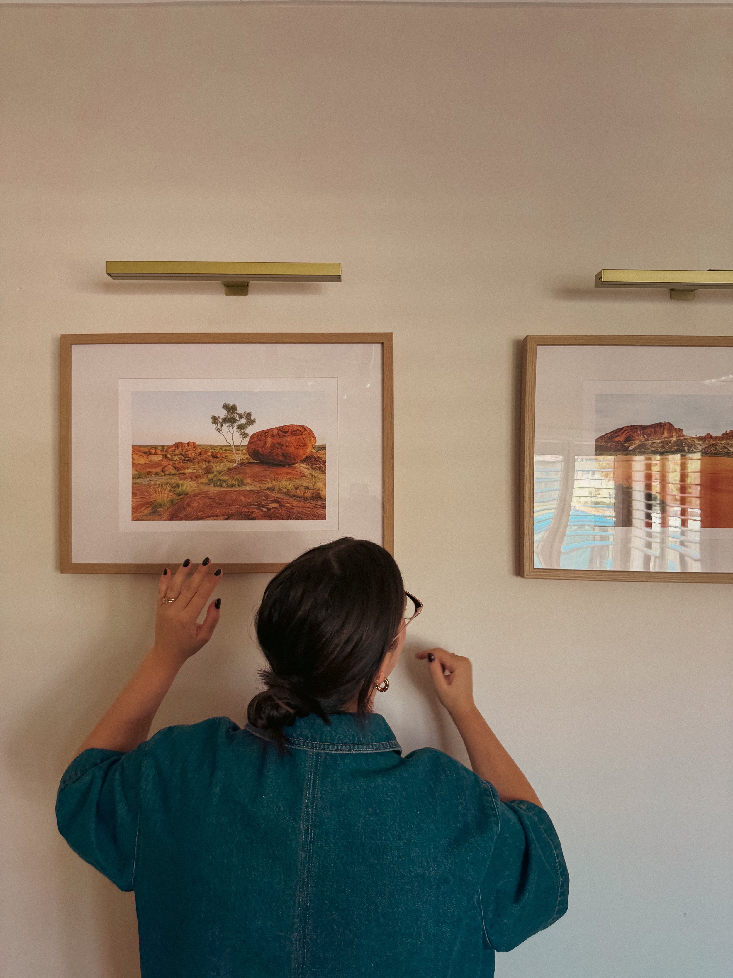 Jess Bortolazzo from Bortolazzo Interior Design styling two framed images with feature lighting