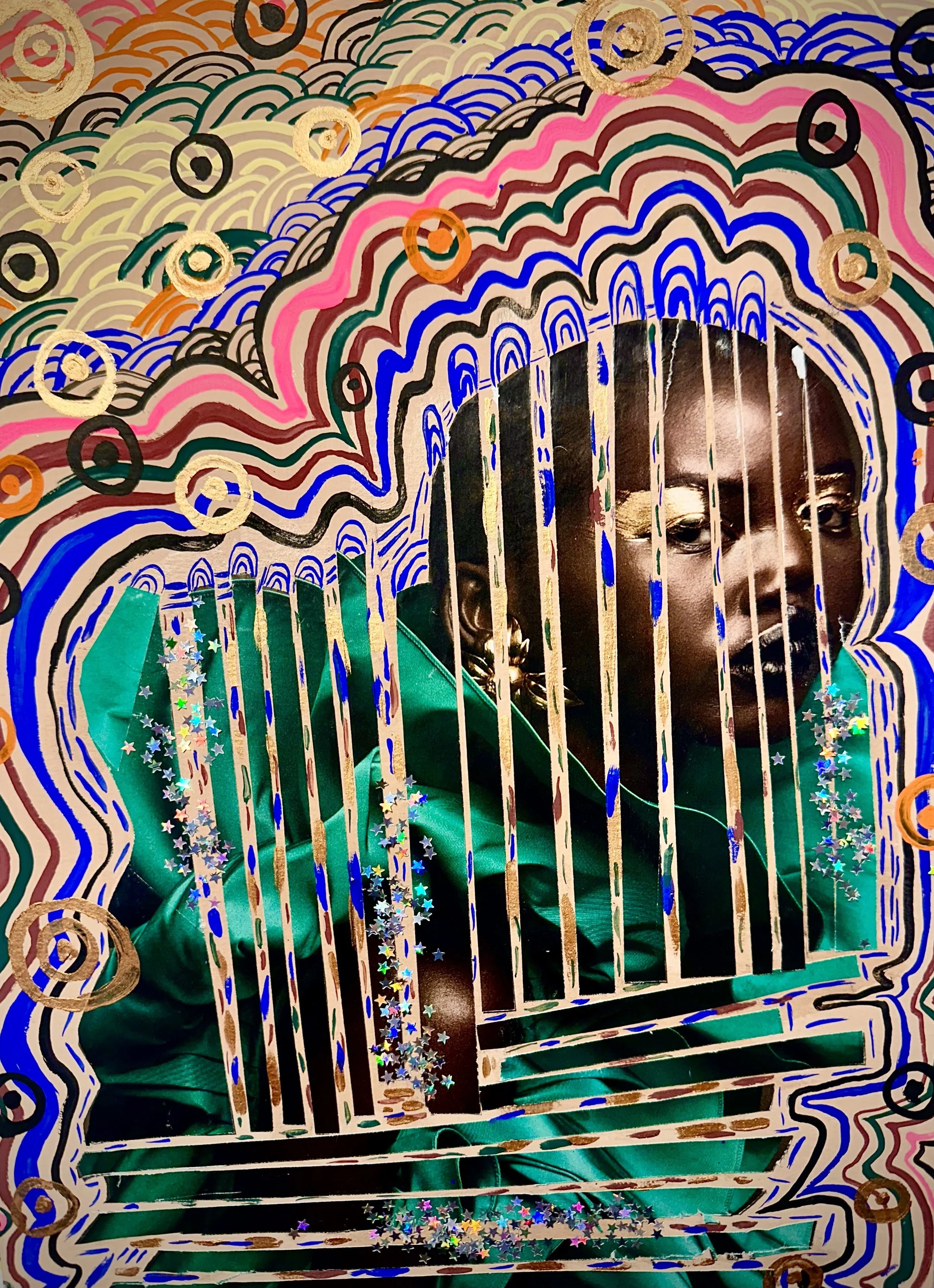 A person with dark skin and short hair  framed by a vibrant, swirling, abstract border with various colors like pink, red, blue, black, beige, and green, and decorated with star-shaped confetti.