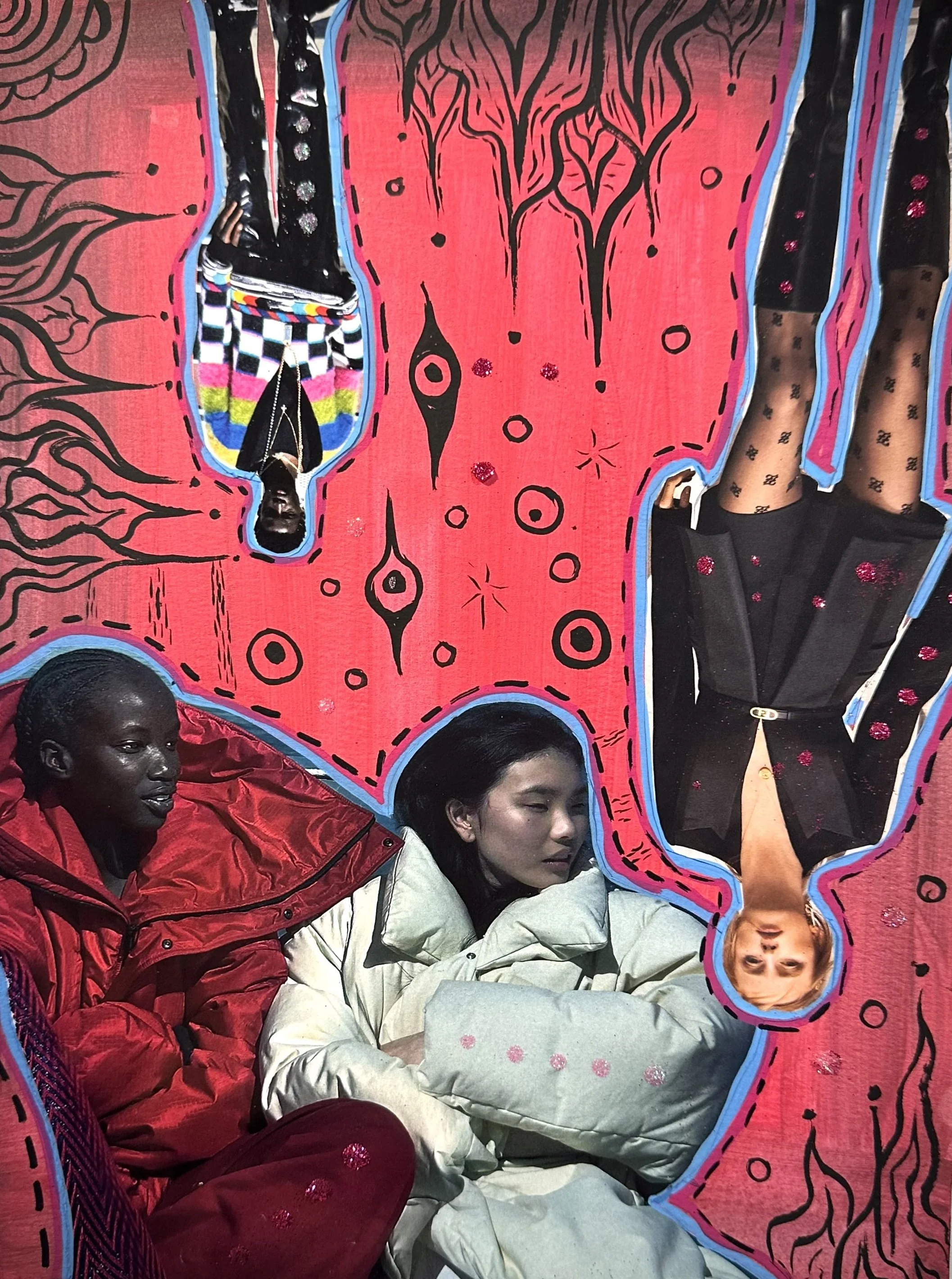 Three women resting inside a vibrant, artistically decorated space with a pink and black abstract mural. One woman wears a red jacket, another in a white puffy jacket with a pillow, and the third is in a red jacket. The space features illustrations and colorful clothing, creating a cozy, artistic atmosphere.