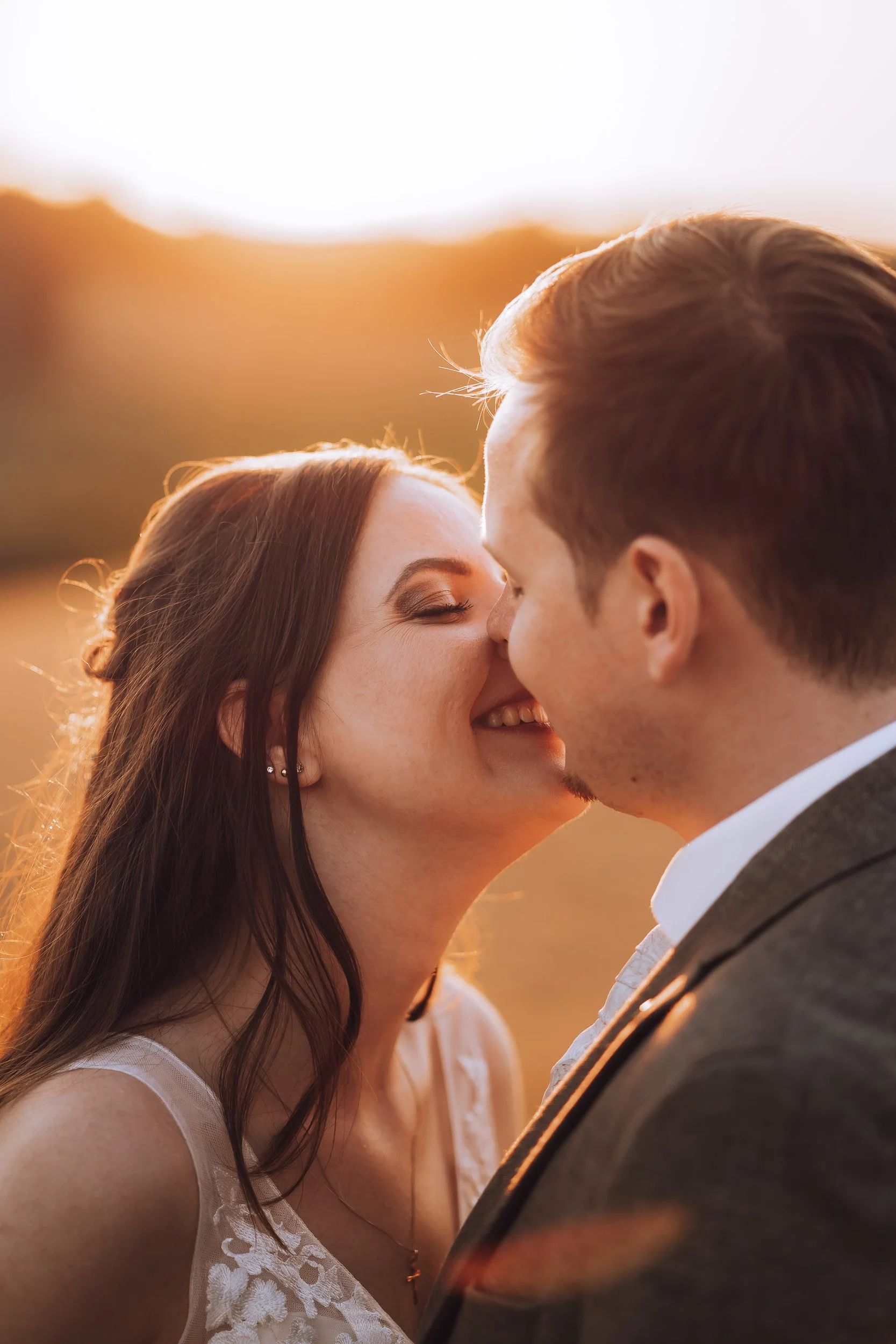 Ein verliebtes Paar bei Sonnenuntergang, das sich küsst.