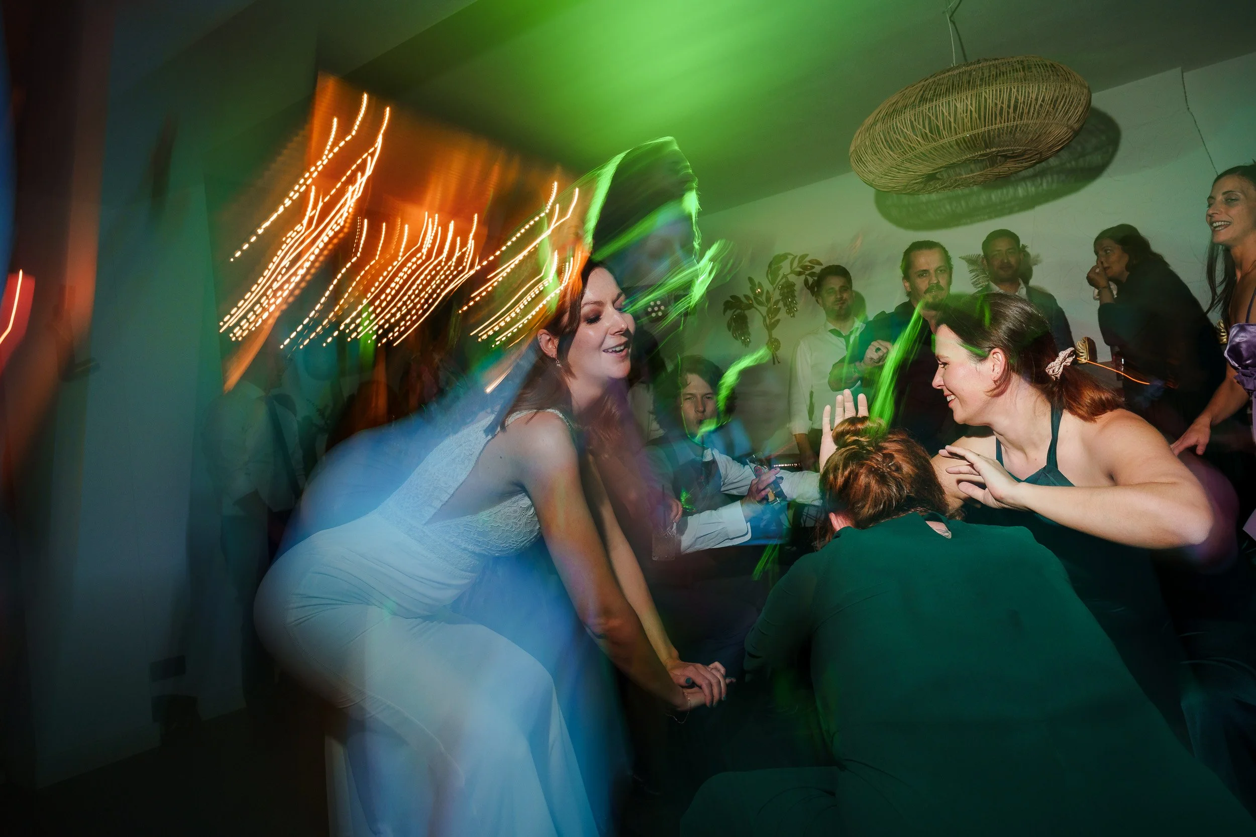 Menschen feiern auf einer Party, bunte Lichter, Tanz, und fröhliche Stimmung