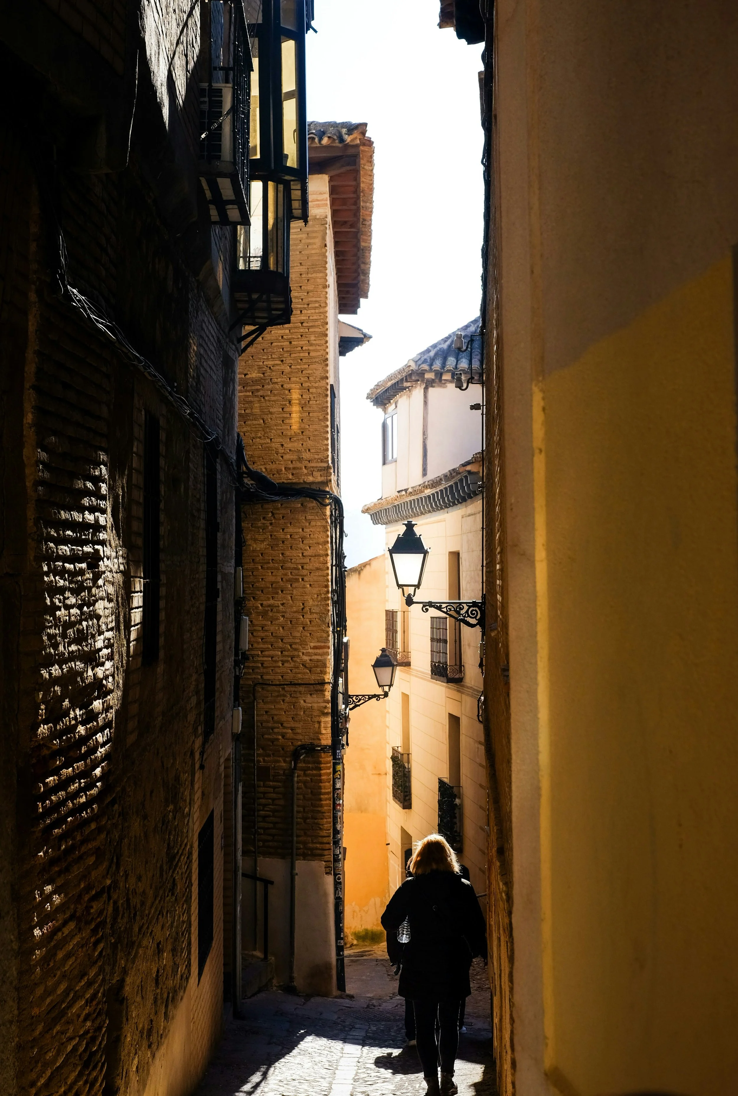 Walking through a historic alley in an old town in Spain