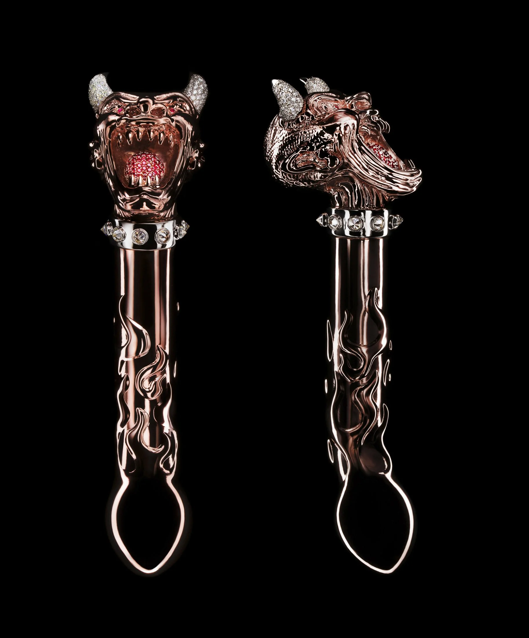 Two decorative scepters with metallic dragon heads, adorned with crystals and spikes, set against a black background.