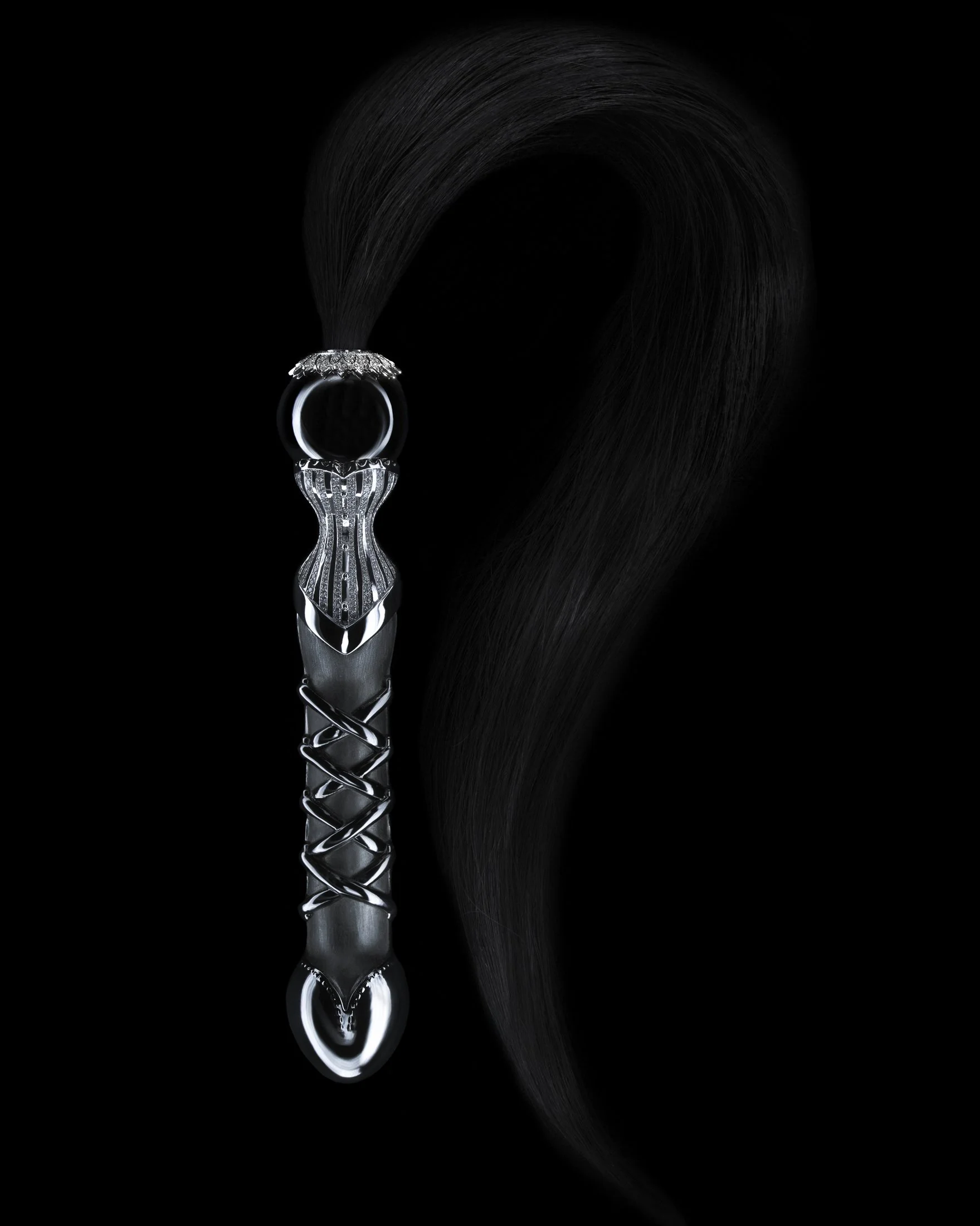 A black hair extension with a metallic handle and a hairbrush ring at the top, against a black background.