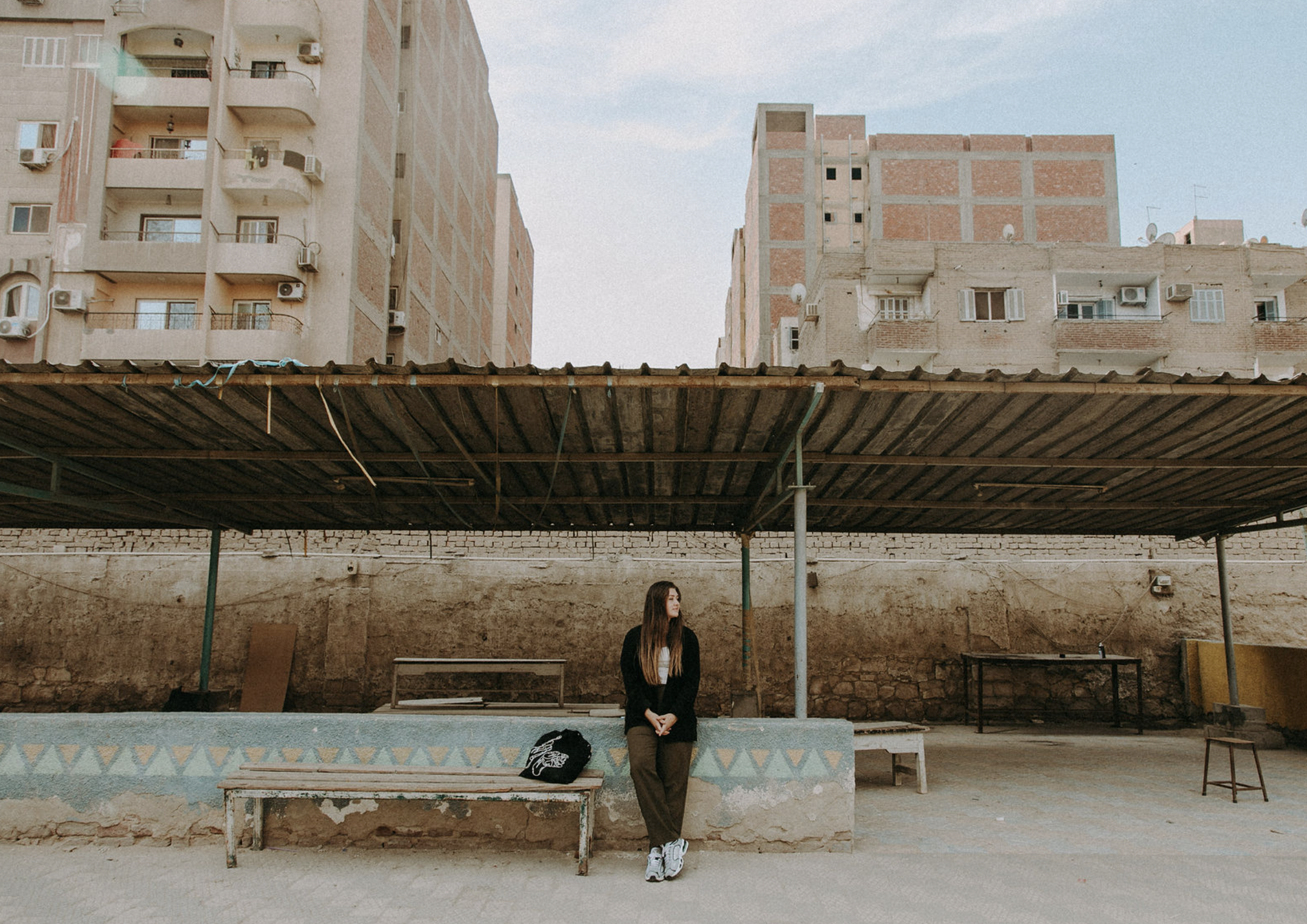 Group of women celebrating at a party, one wearing a flower crown, decorated with balloons and wall art in the background.