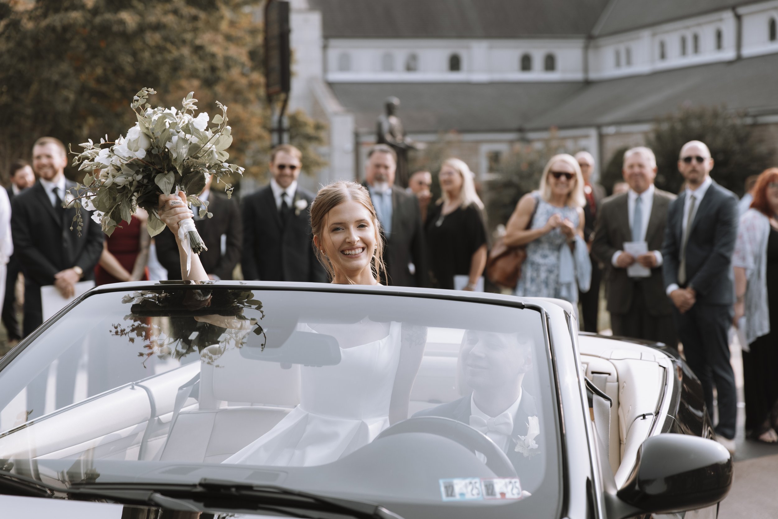maryland wedding couple celebrating in a car surrounded by family