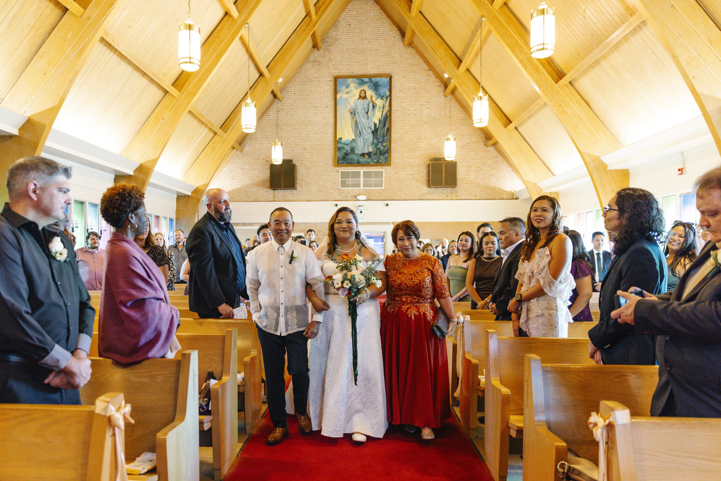 maryland bride walking down the isle with family in a beautiful church