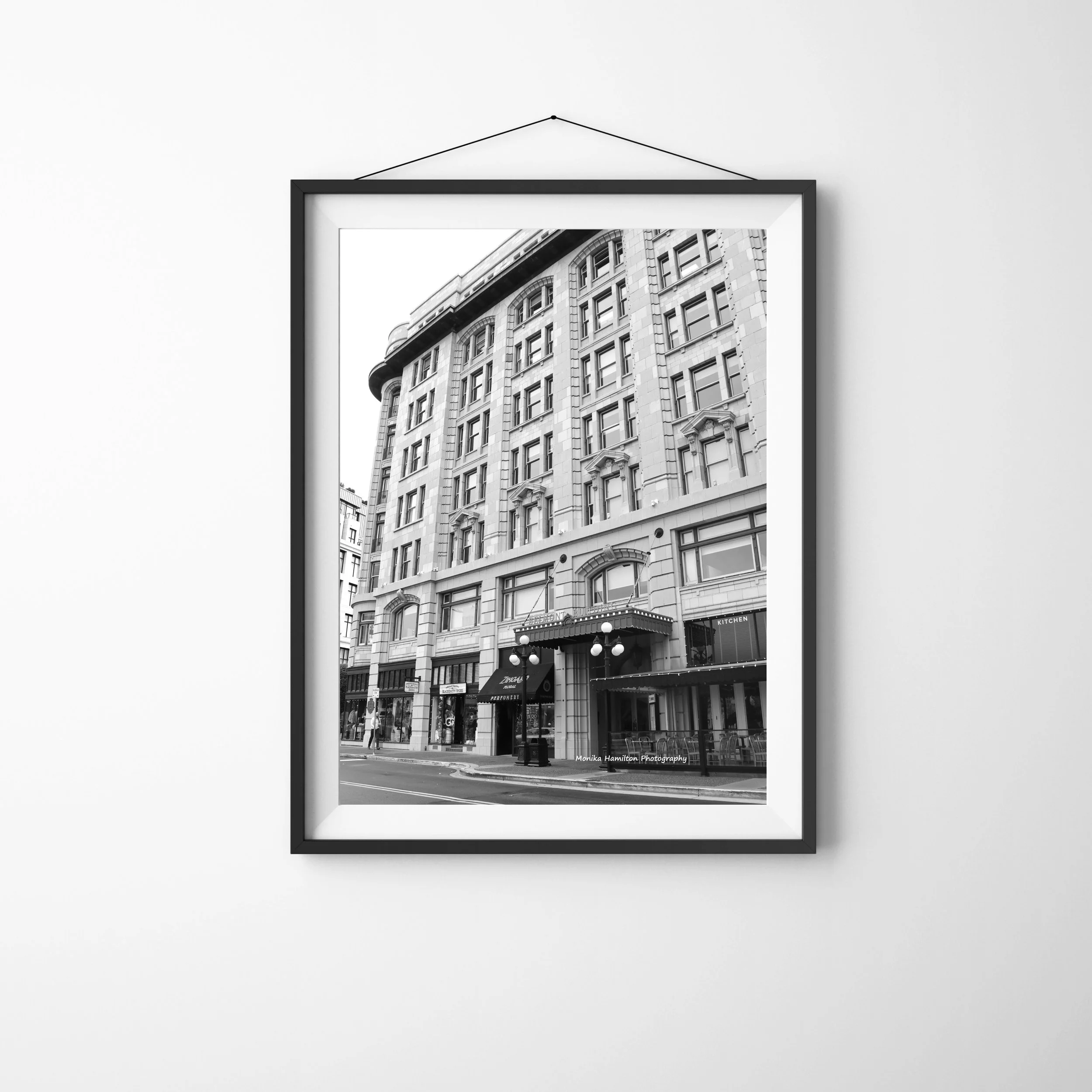 The Belmont Building in Victoria, BC - black and white vertical photo of historic architecture, street lamps, and city storefronts. Monika Hamilton Photography