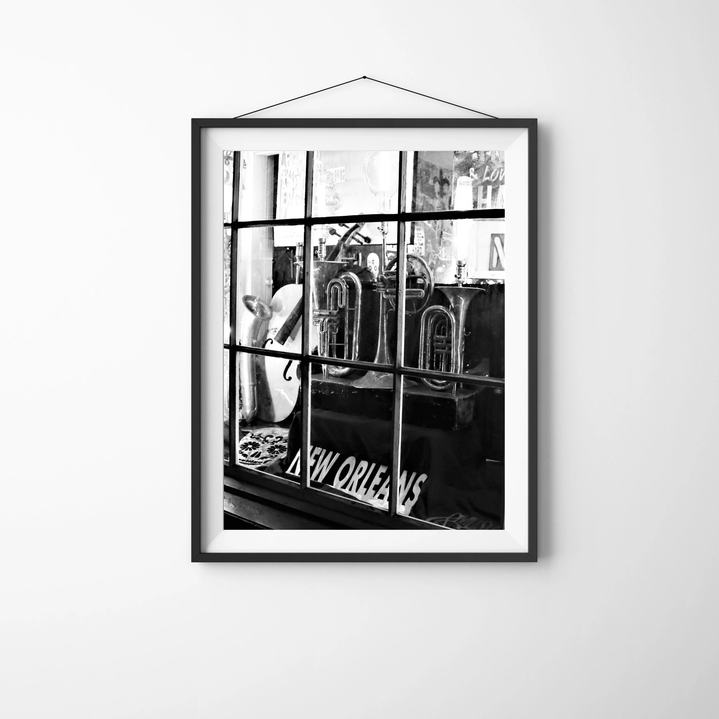 New Orleans Storefront Window at Night - vertical black and white photo of musical instruments seen through a shop window. Part of the New Orleans Night Scenes Collection. Monika Hamilton Photography