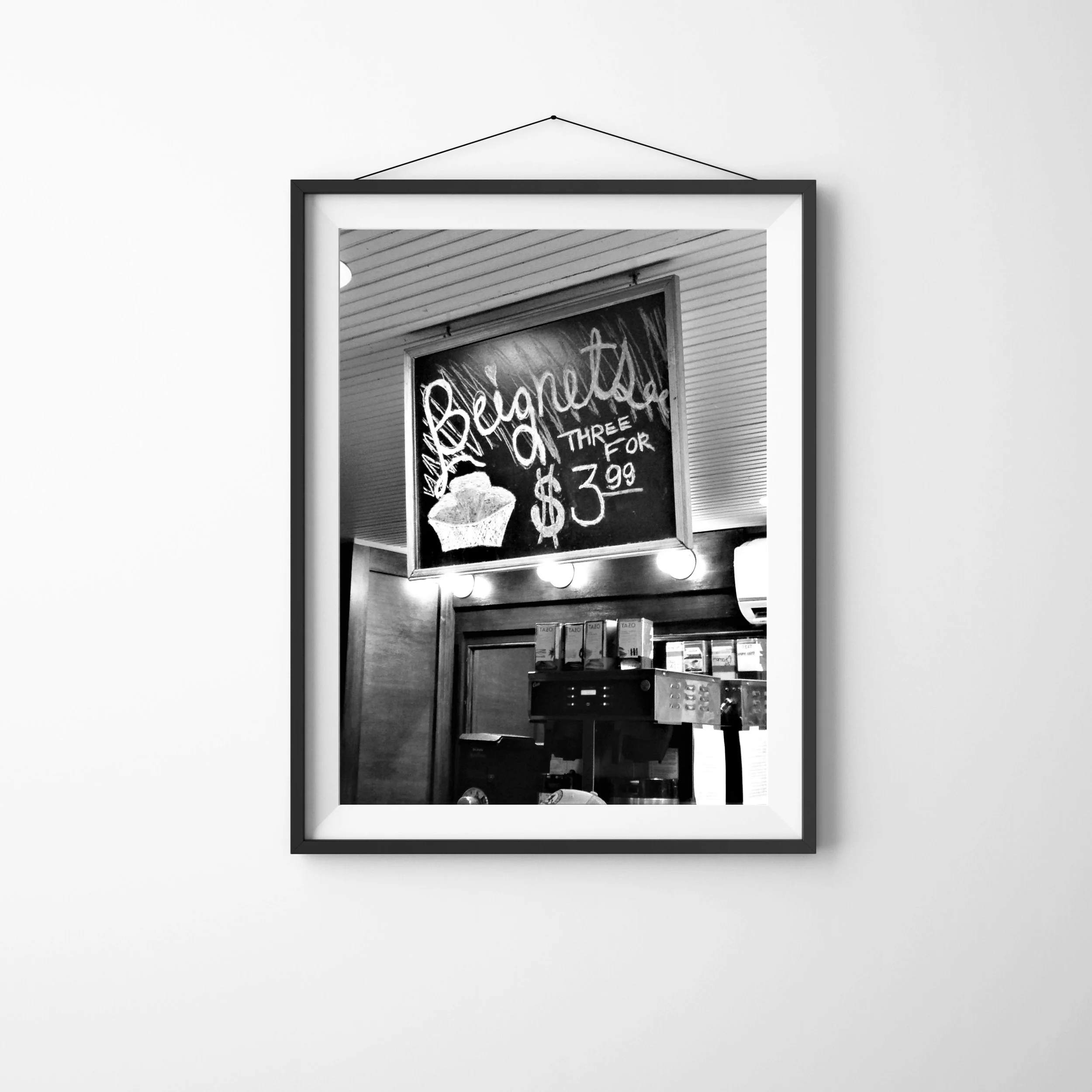 New Orleans Cafe Sign - vertical black and white photo of a chalkboard sign at the popular Jazz in the Park Cafe at night advertising a special offer for Beignets. Part of the New Orleans night scenes collection. Monika Hamilton Photography