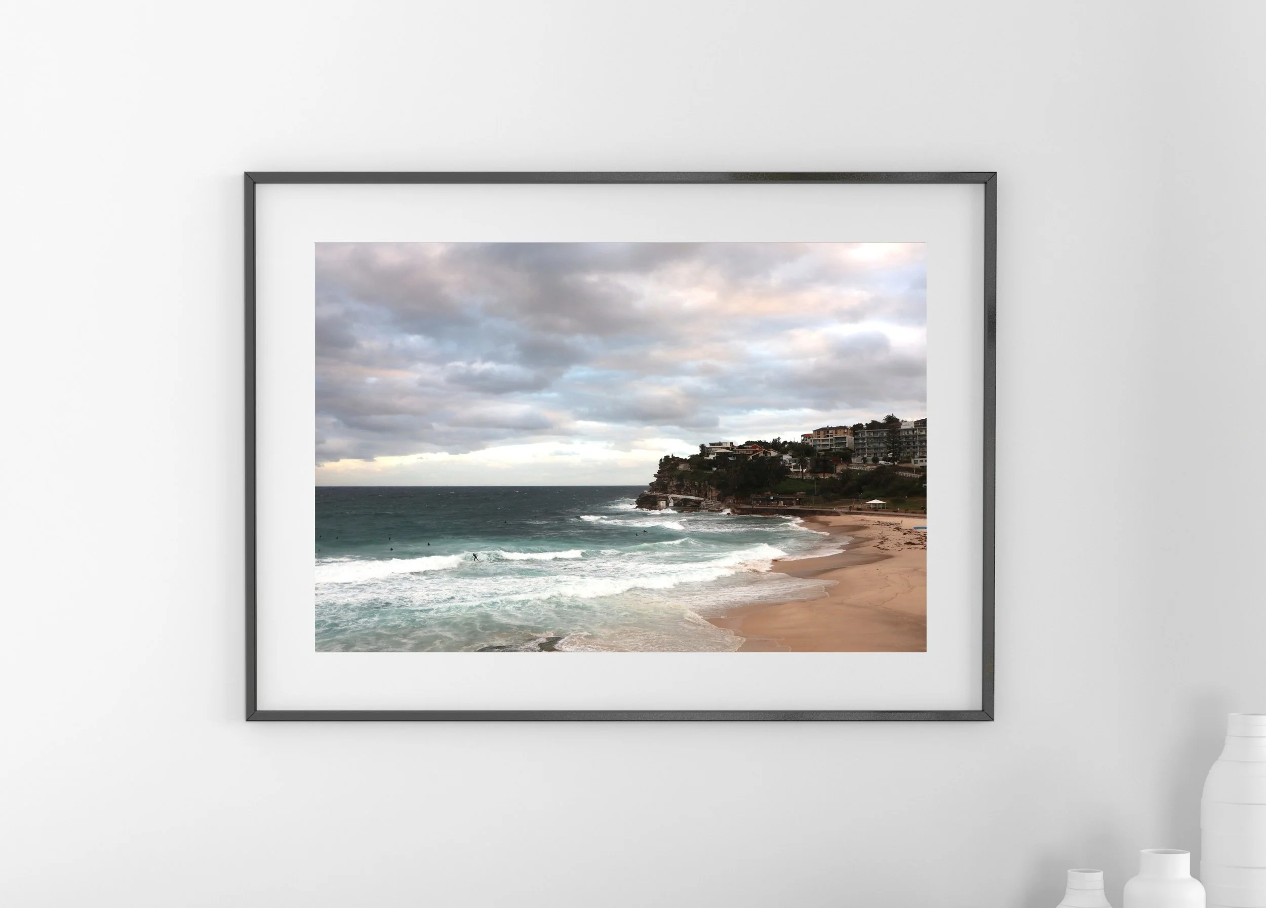 Bronte Beach, New South Wales, Australia - a cloudy, windy early evening with surfers tackling the waves.