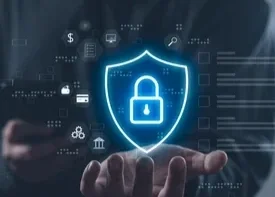Hand holding a digital shield icon with a lock, representing cybersecurity or data protection.