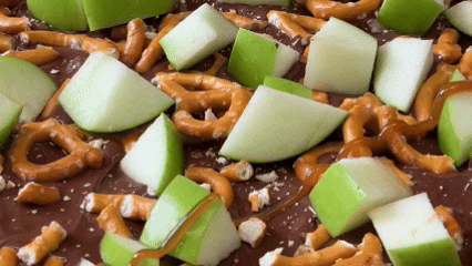 Close Up / Chocolate drizzle over apple, pretzels and chocolate