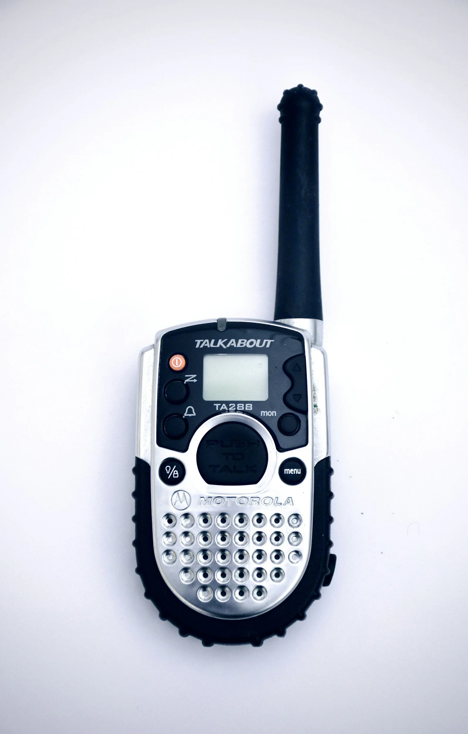 A Motorola talkabout walkie-talkie with an antenna on a white background.