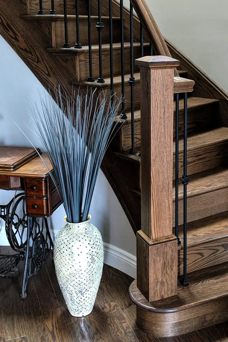 Custom Stained Oak Stair Recap Featuring Red Oak Box Newel and Satin Black Metal Spindles