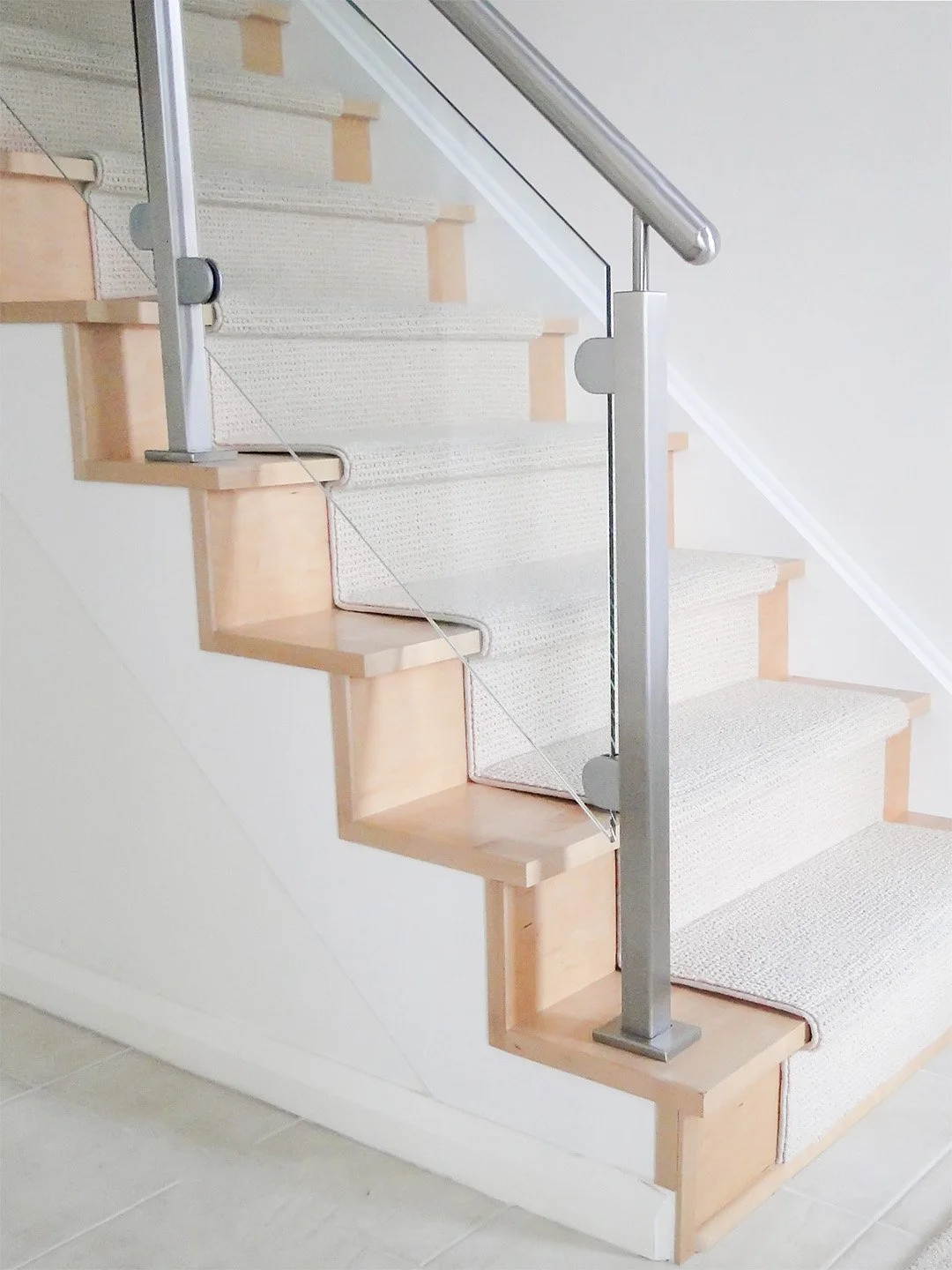 Stainless steel and glass handrail on maple stair recap in the Glebe, Ottawa by Campbell's Woodcraft