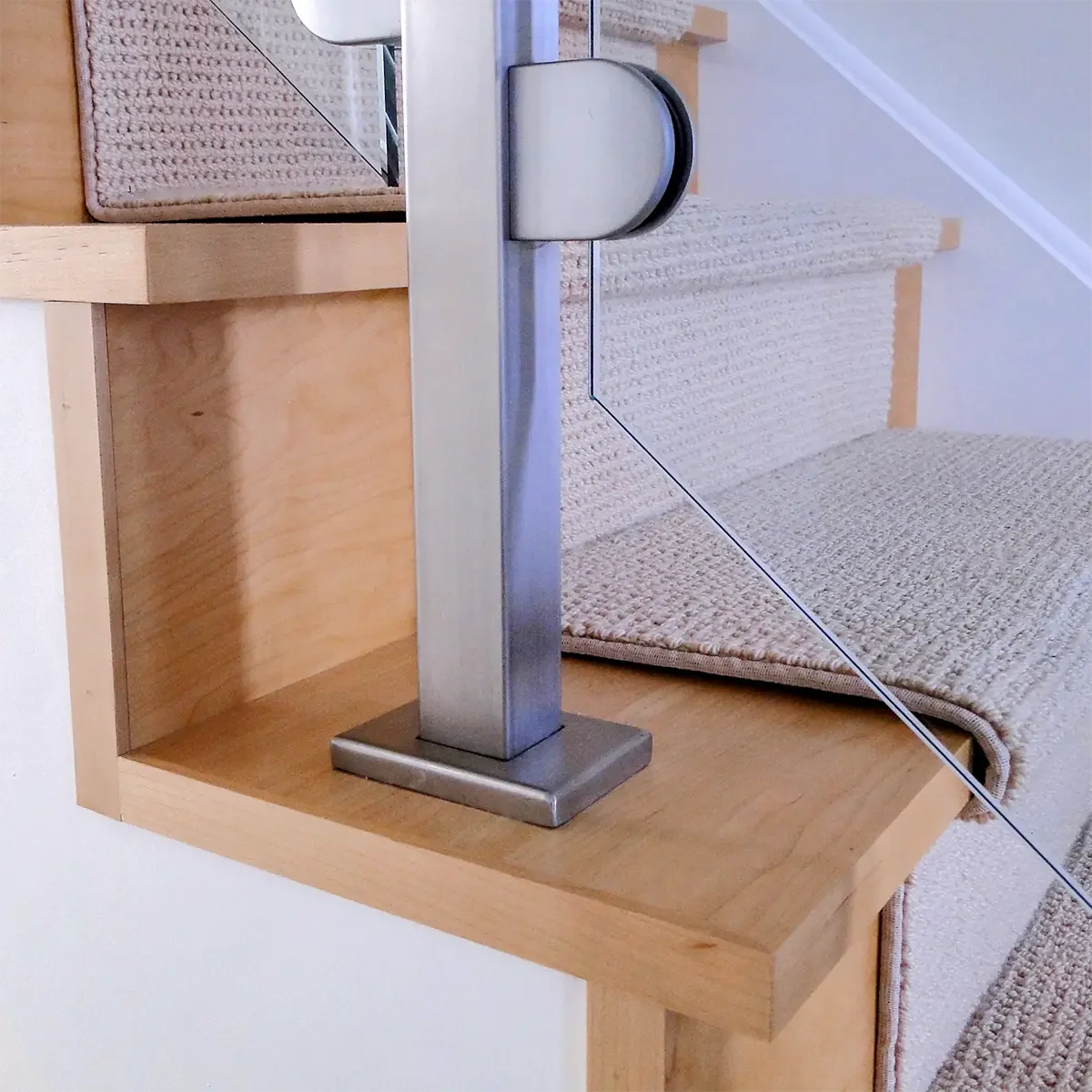 Ultra modern maple stair with stainless steel railing posts and glass panels in Carleton Place