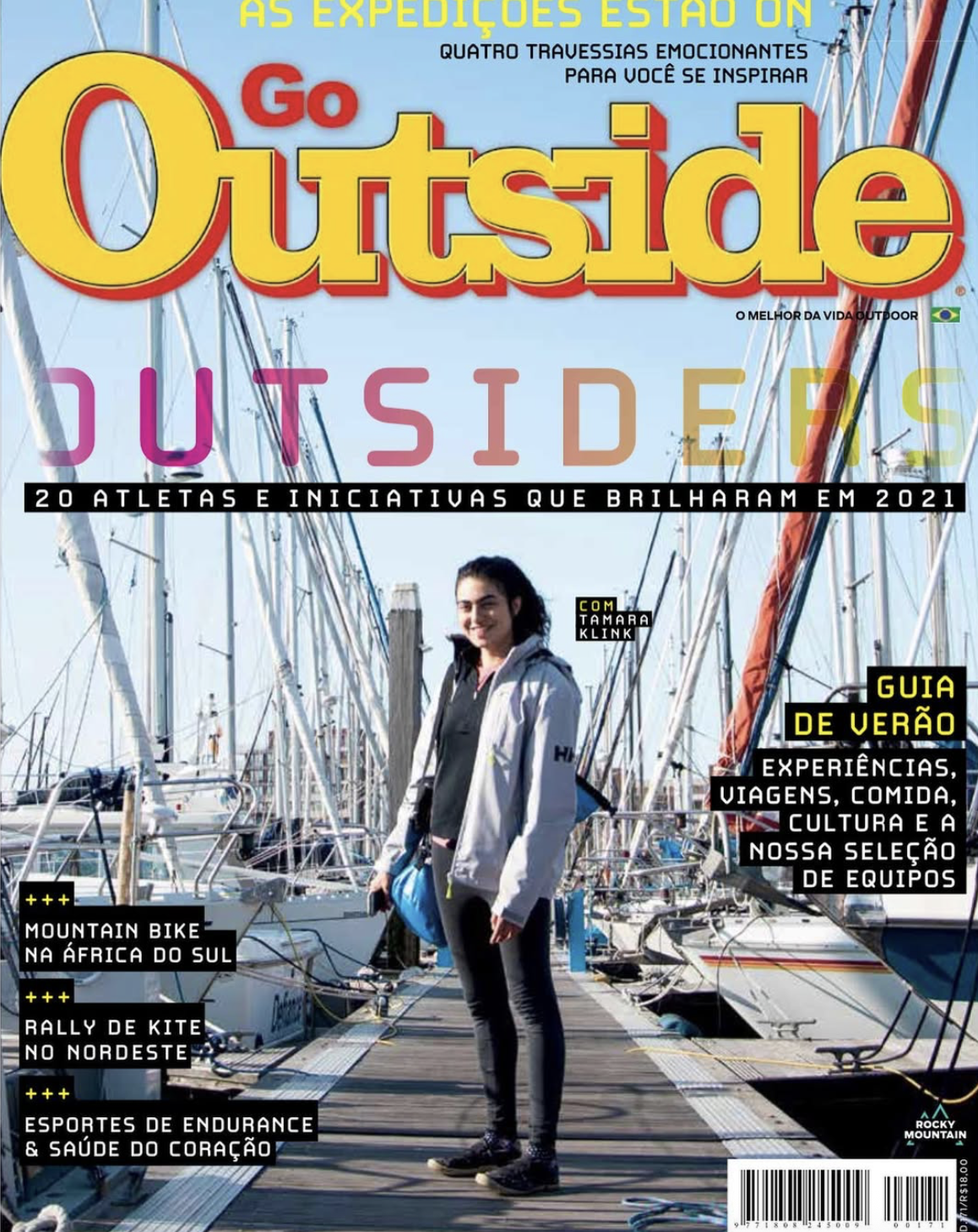 A woman standing on a dock surrounded by sailboats, smiling, with a magazine cover layout featuring large colorful text and headlines about outdoor activities and adventure sports.