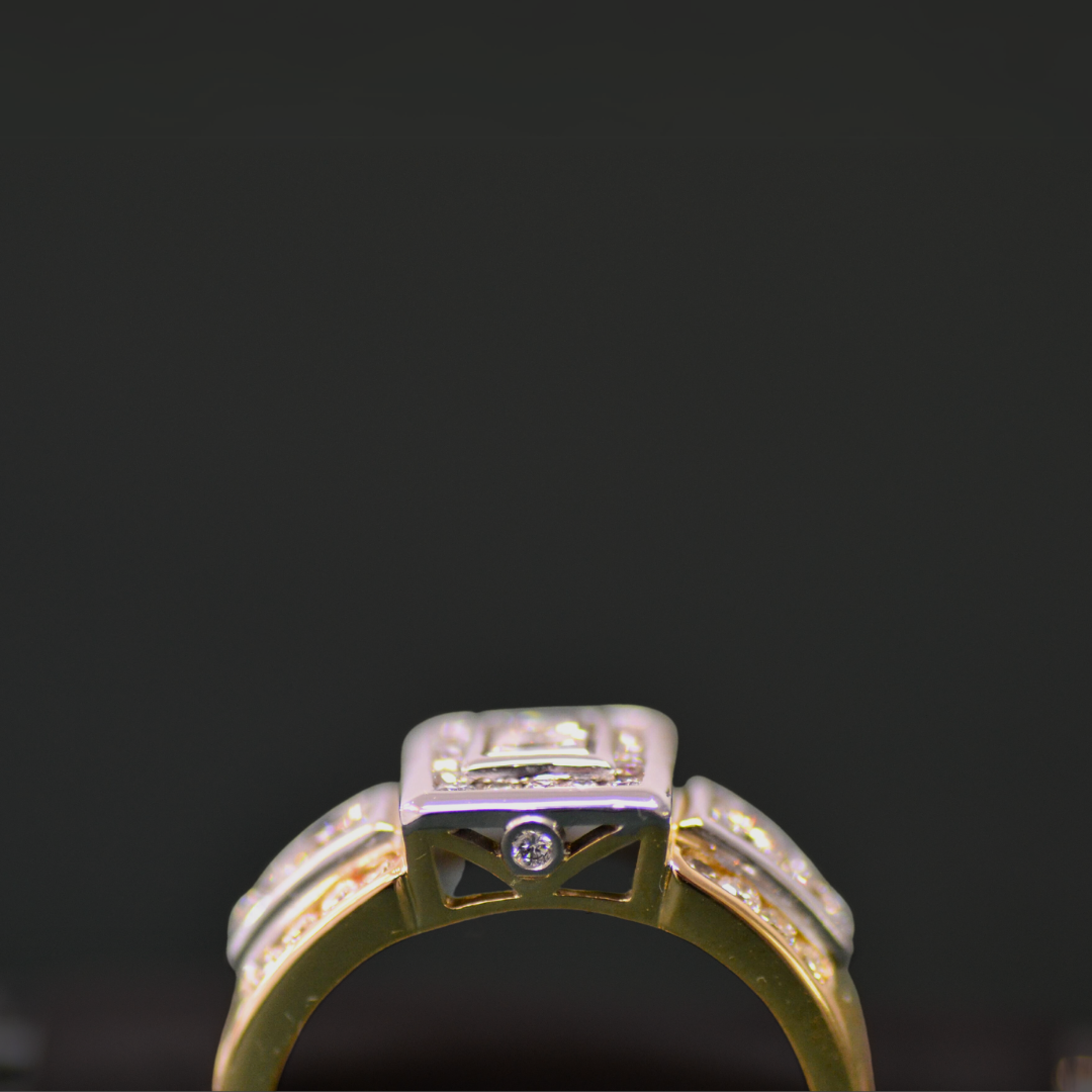Close-up of a gold and silver ring with embedded diamonds against a black background.