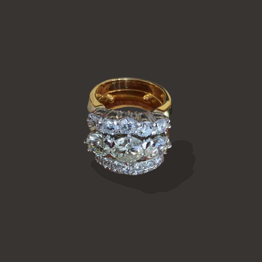 Gold ring stacked with multiple rows of large, clear diamonds.