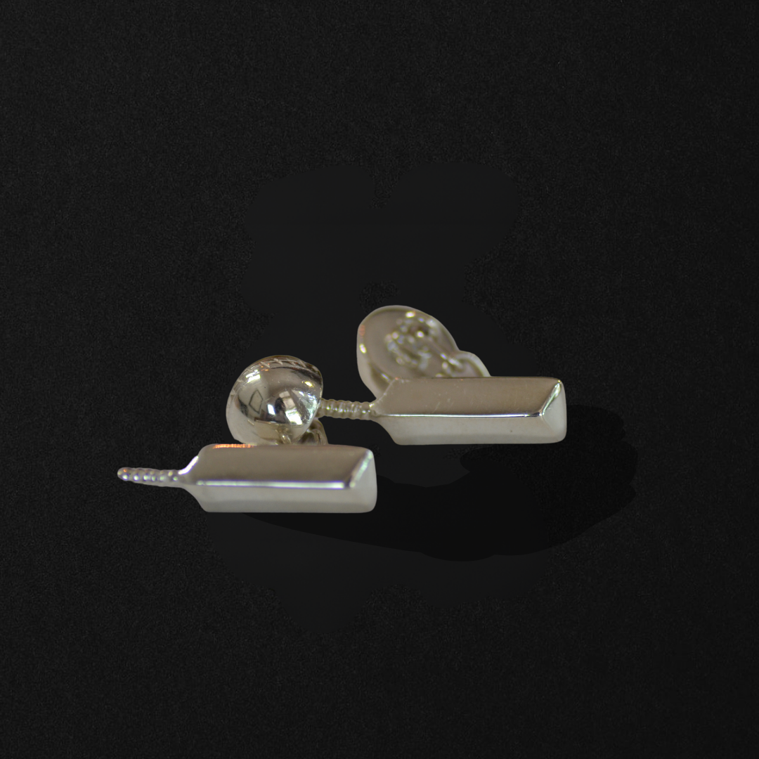 Pair of silver cufflinks with rectangular design and spherical components, on a black background.