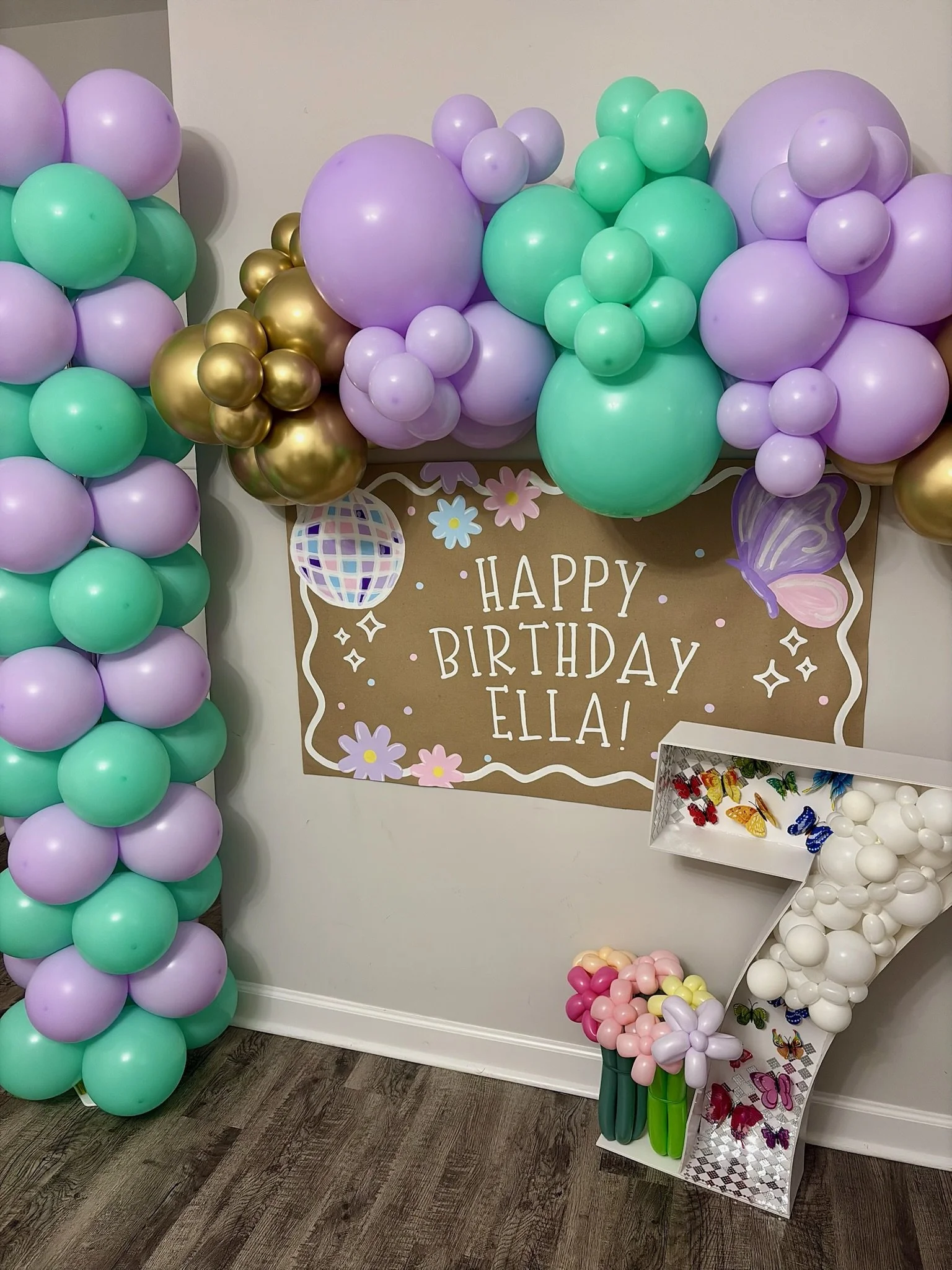 Pastel balloon garland with lavender, mint, and gold balloons for a birthday celebration