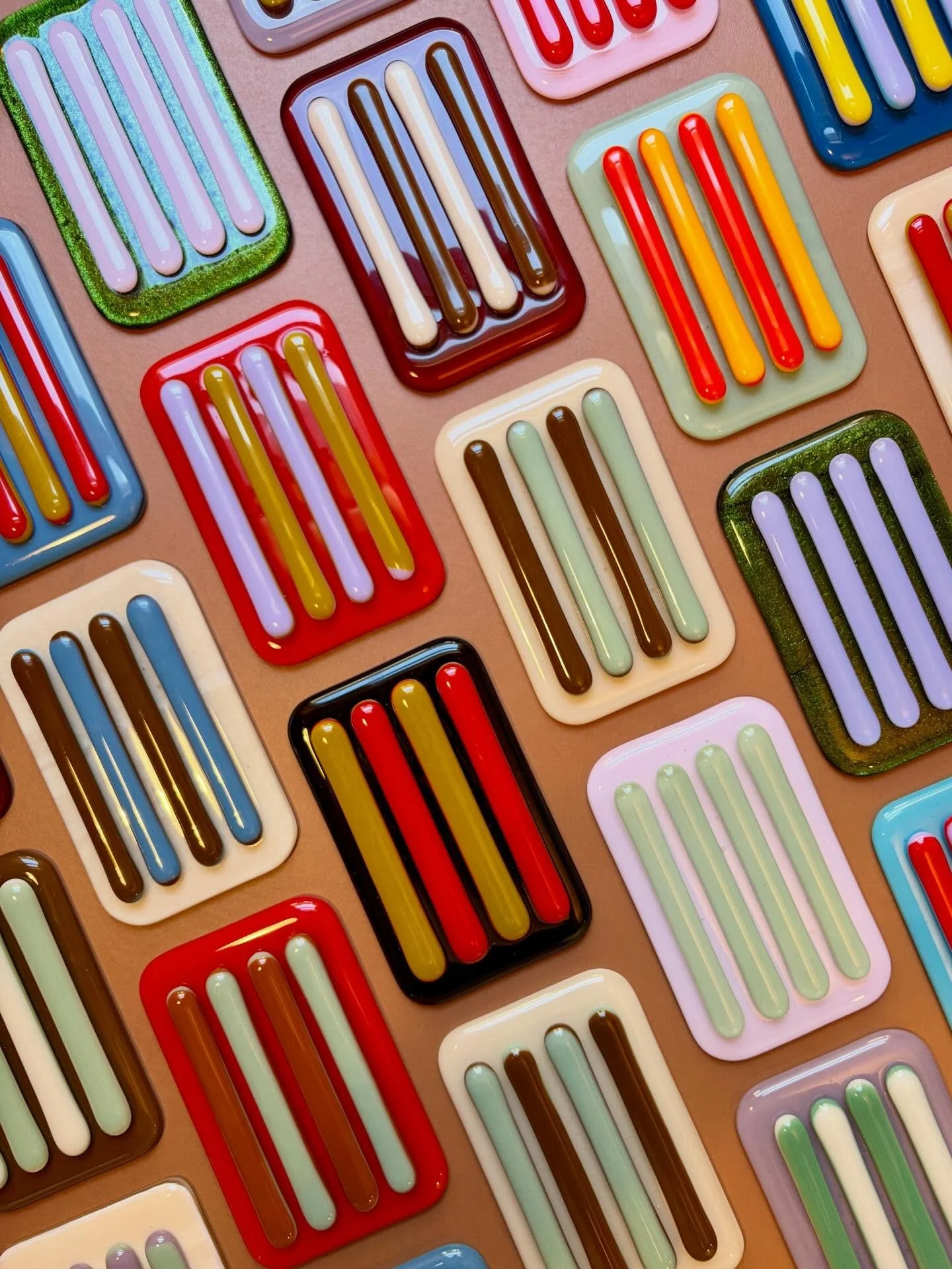 Twenty two glass soap dishes just out of the kiln